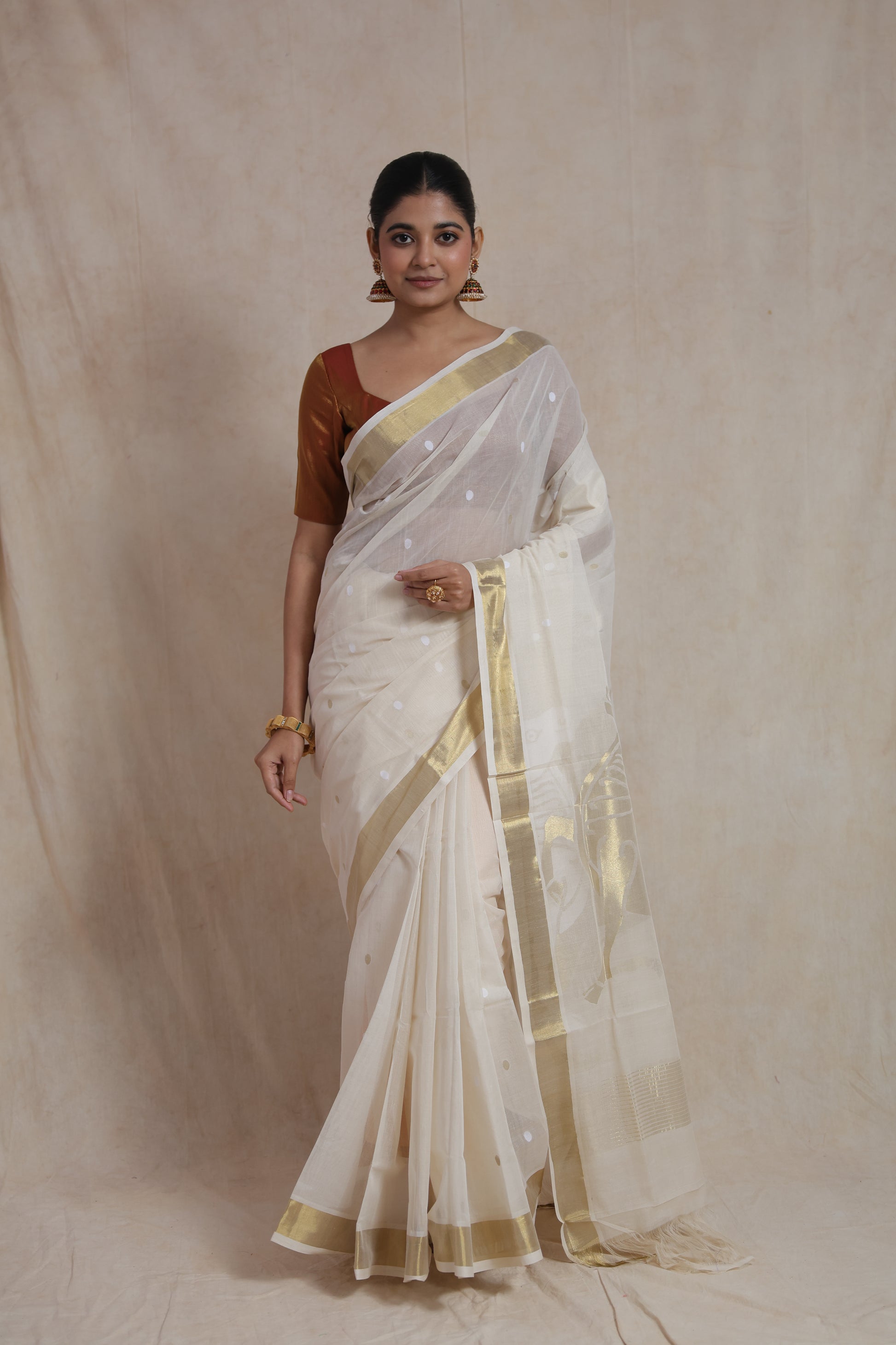 Close-up of off white Kanchipuram cotton saree with woven buttas and zari border