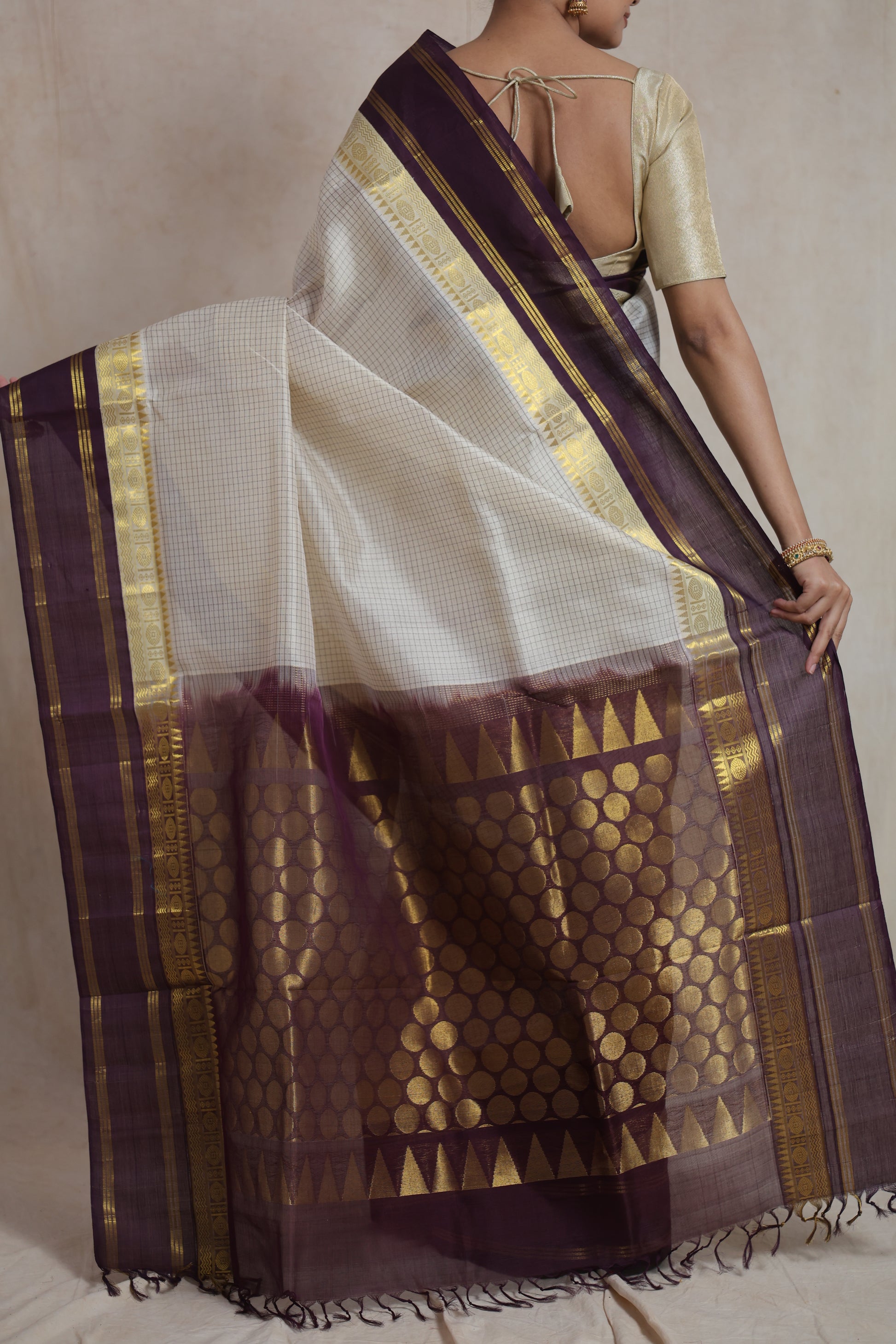 Close-up detail of off white Kanchipuram Sico saree with zari woven border