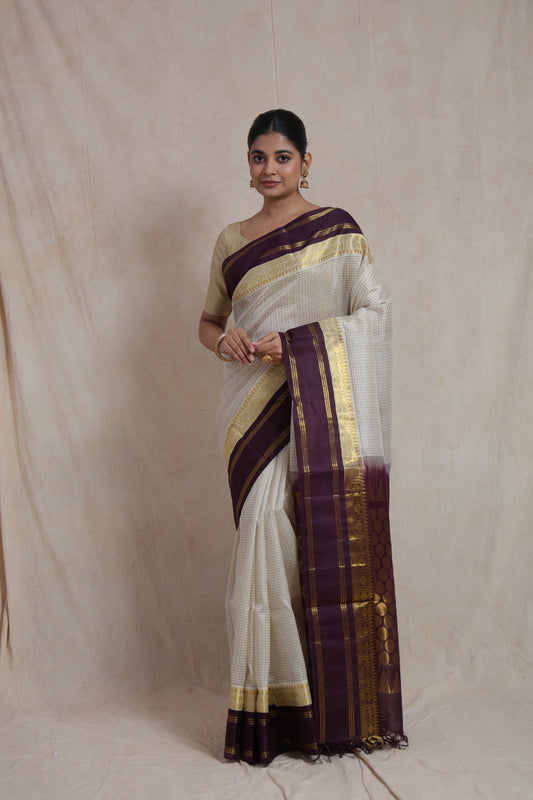 Full view of model wearing off white Kanchipuram Sico saree with rich pallu