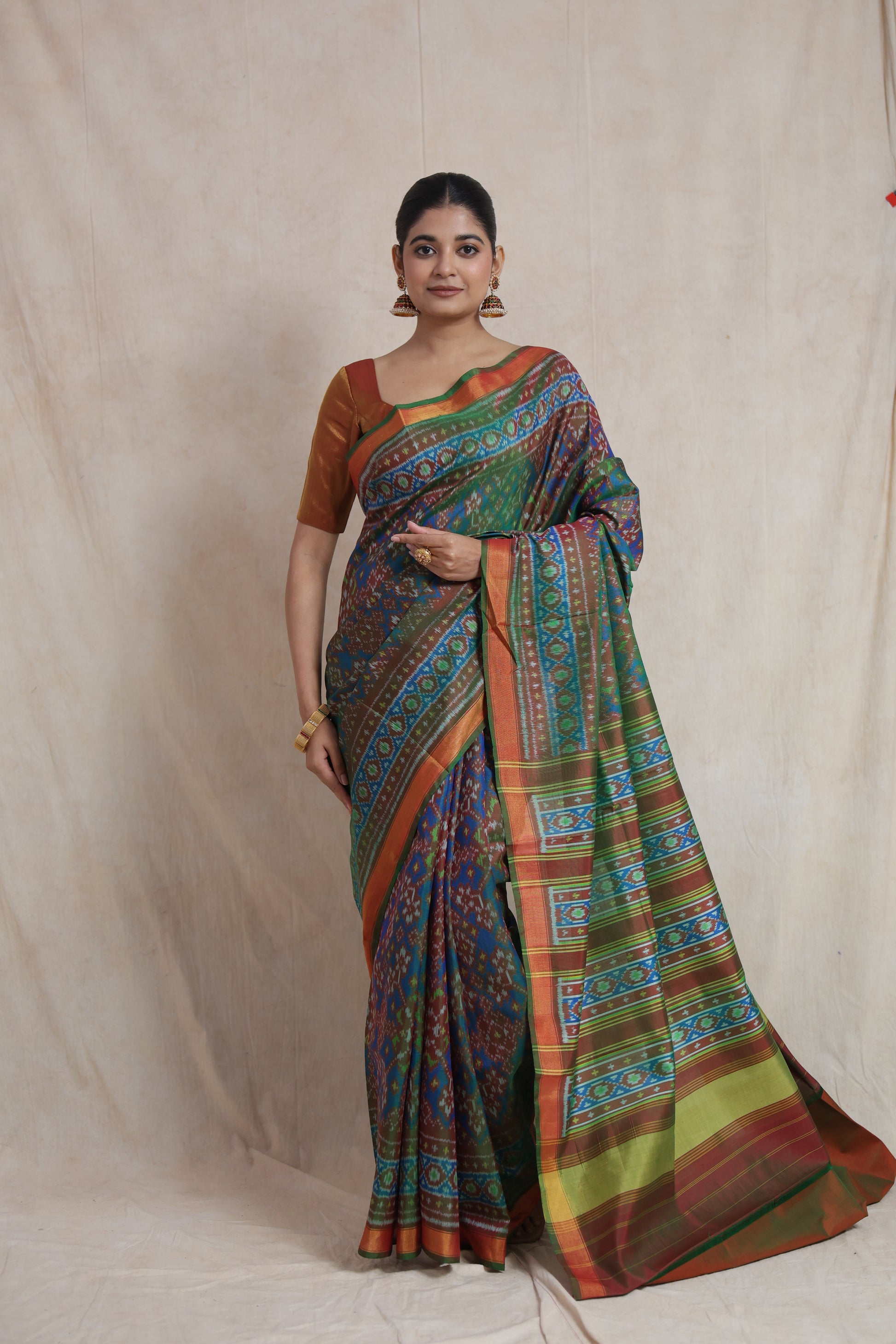 Full-length view of olive green and blue Patola handloom silk saree with traditional ikat motifs