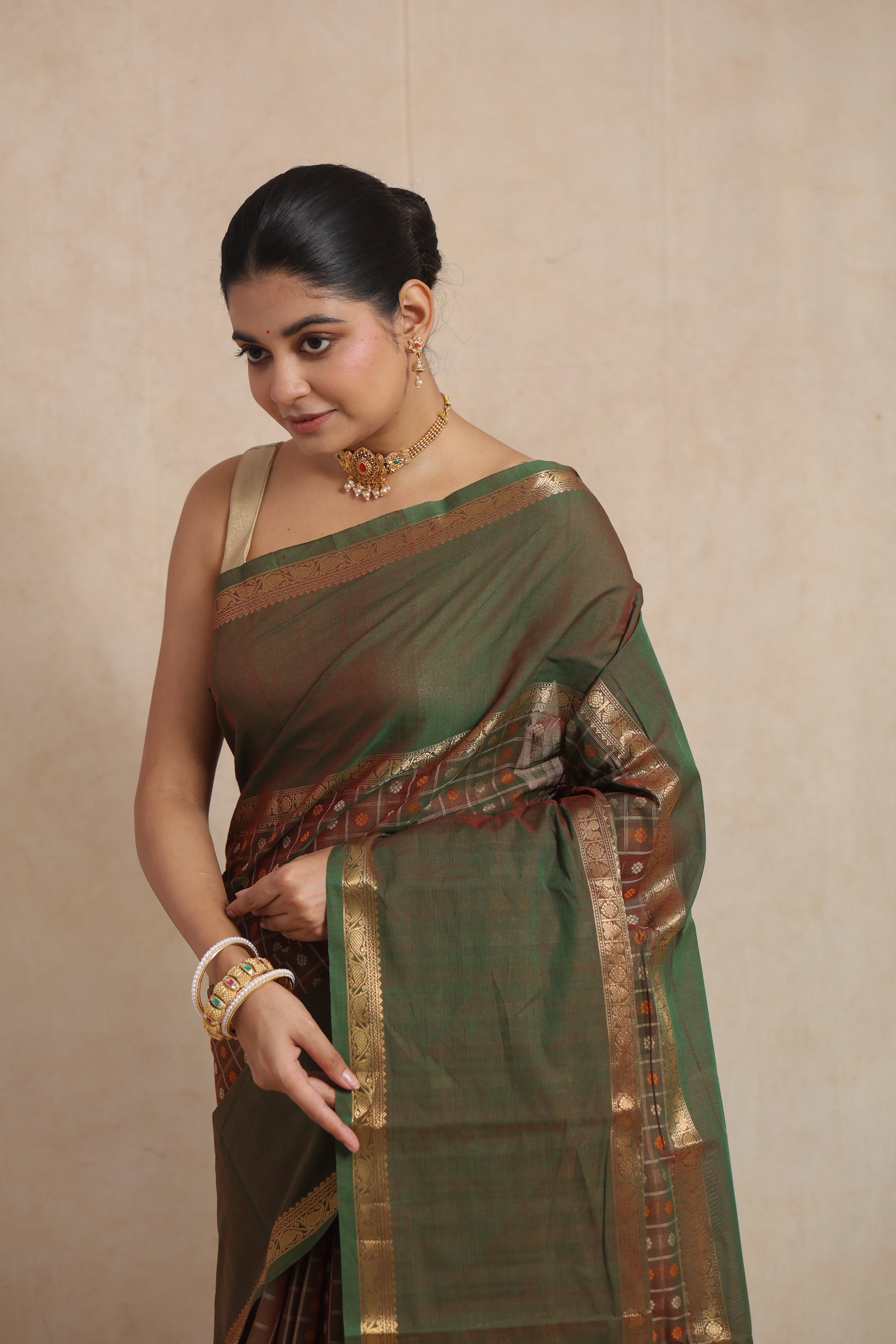 Portrait view of olive green Kanchipuram cotton saree with elegant traditional detailing