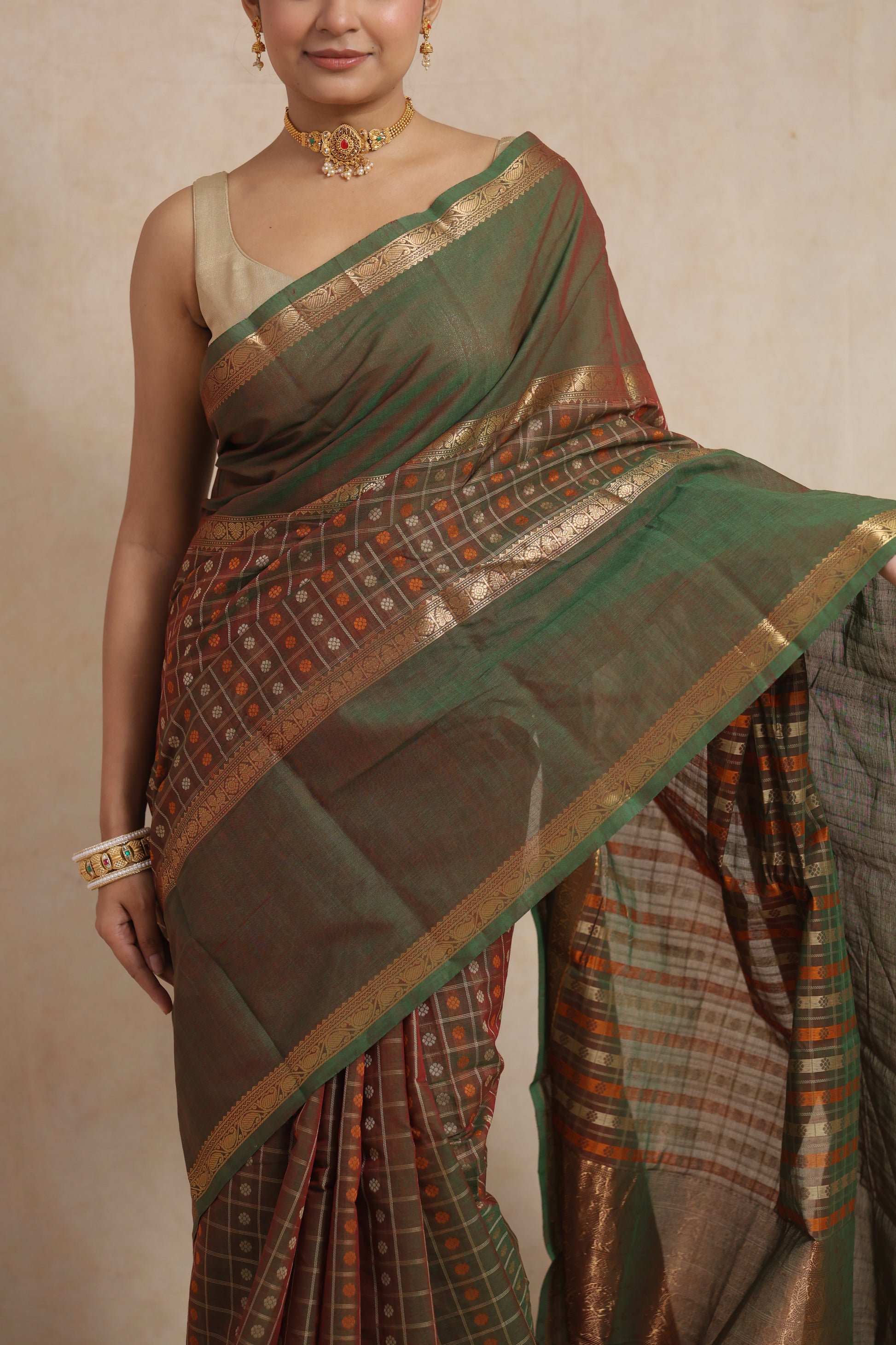 Close-up of olive green Kanchipuram cotton saree with checked weave and rich woven border