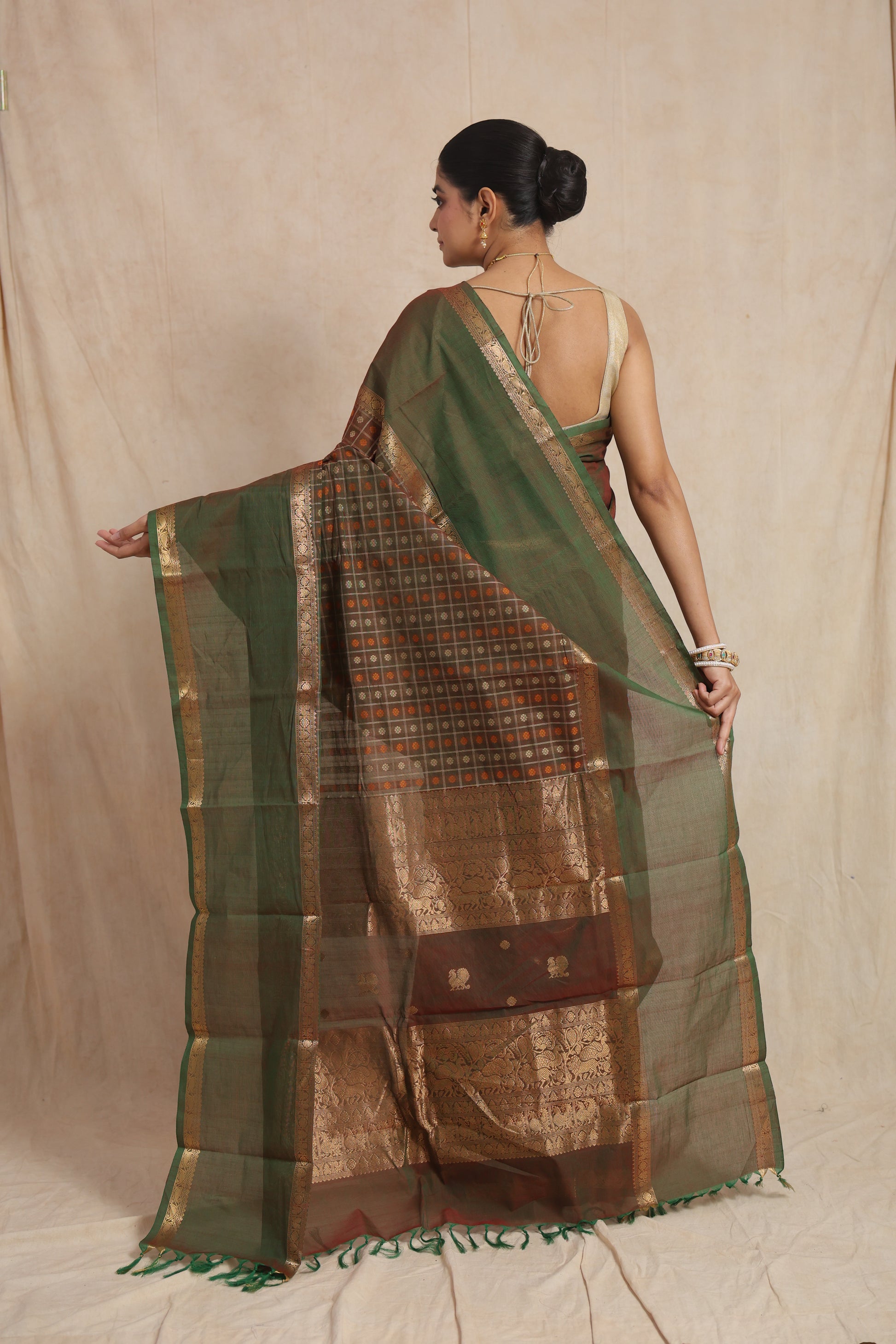Back view of olive green Kanchipuram cotton saree with checked woven pallu and traditional zari border