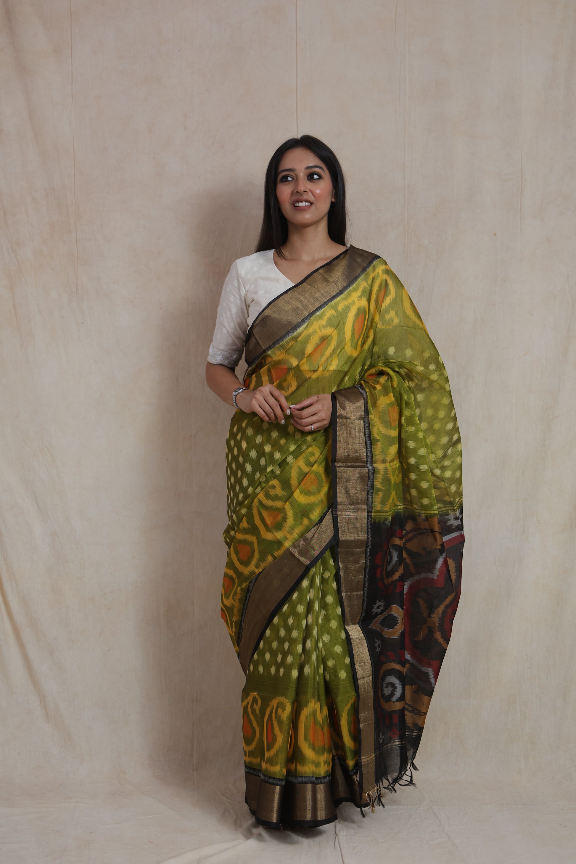 Elegant olive green Pochampally silk cotton saree with woven traditional patterns and rich pallu