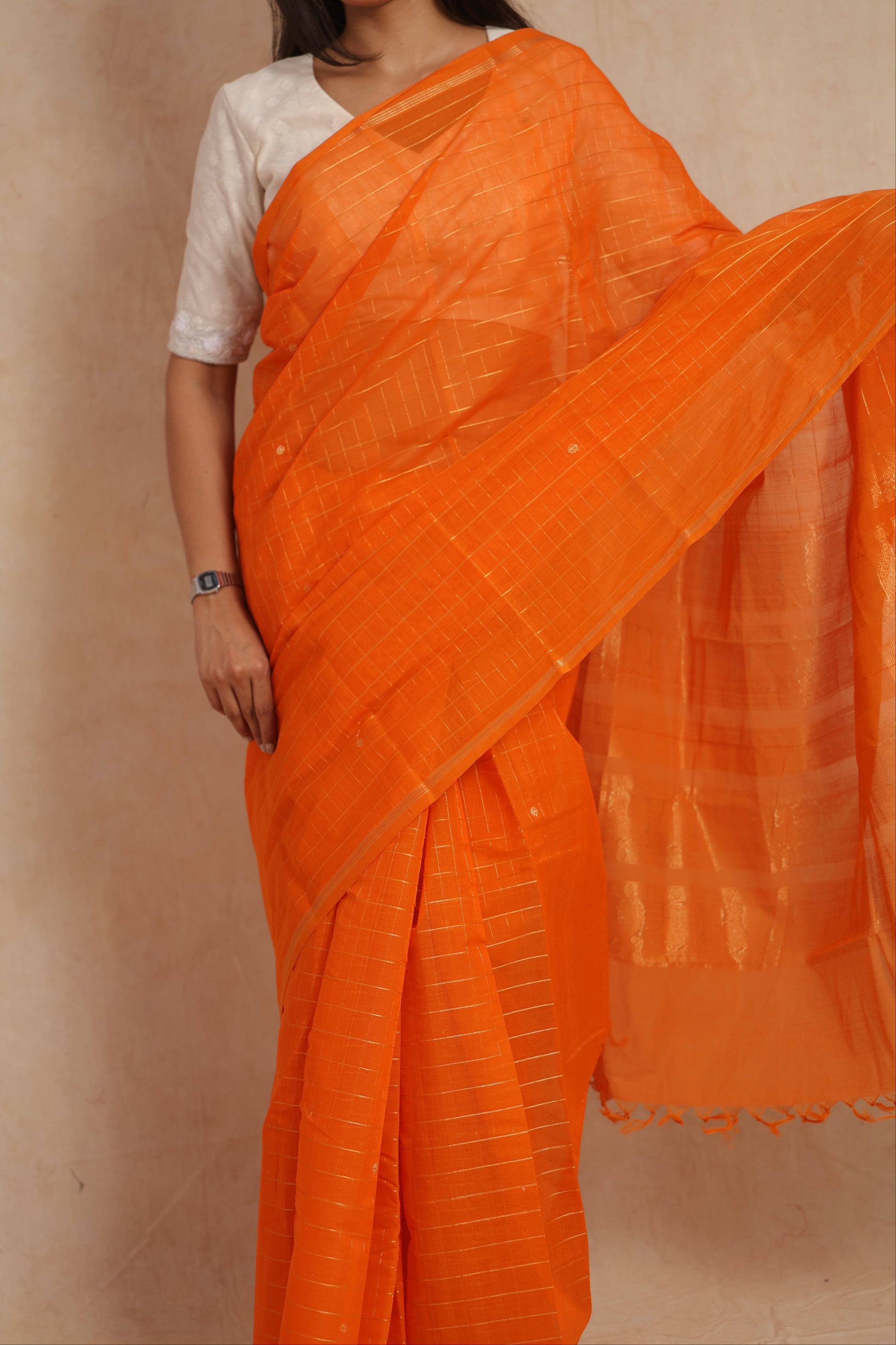 Close-up of orange Kanchipuram cotton saree with woven stripe detailing