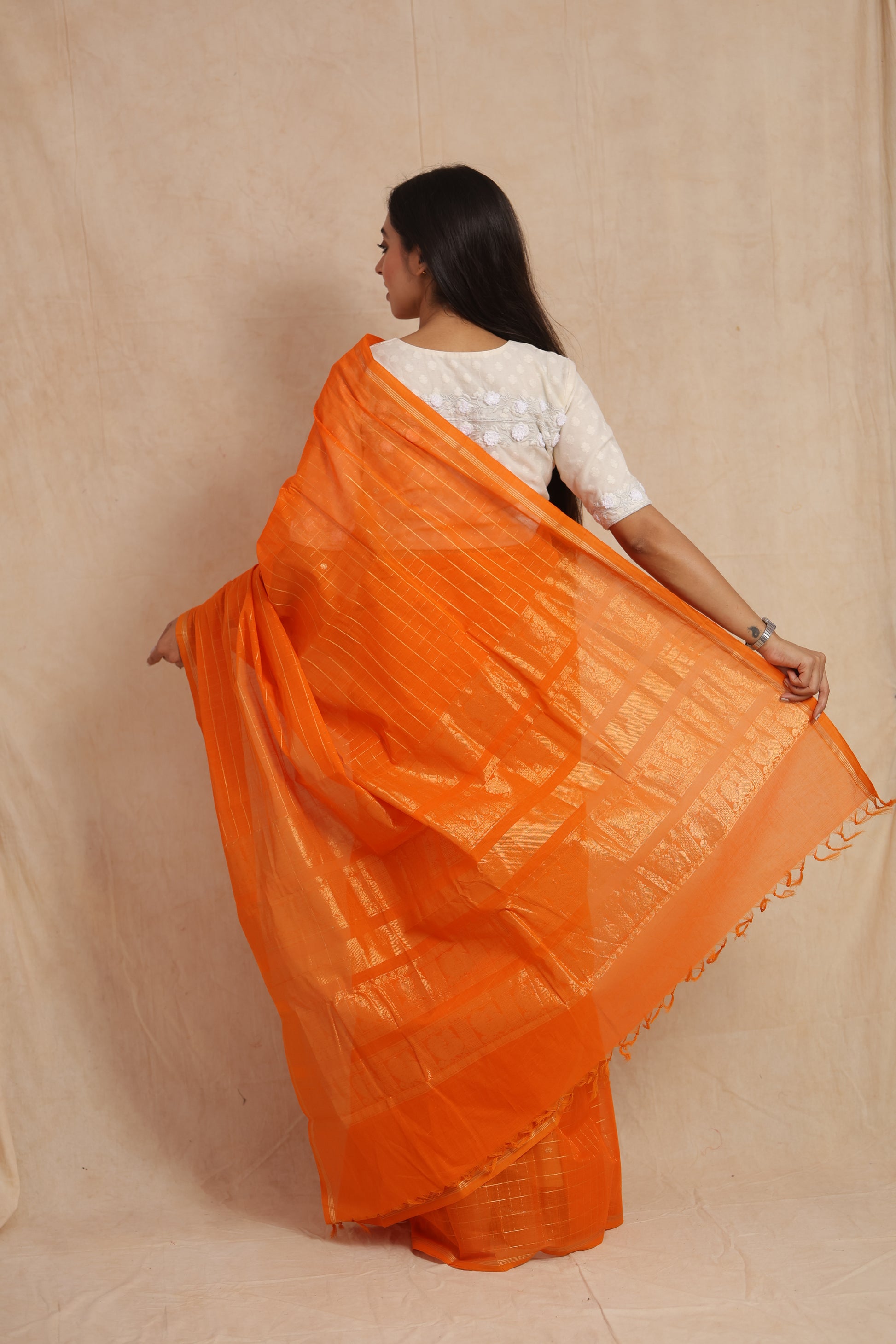 Back drape view of vibrant orange Kanchipuram handloom cotton saree