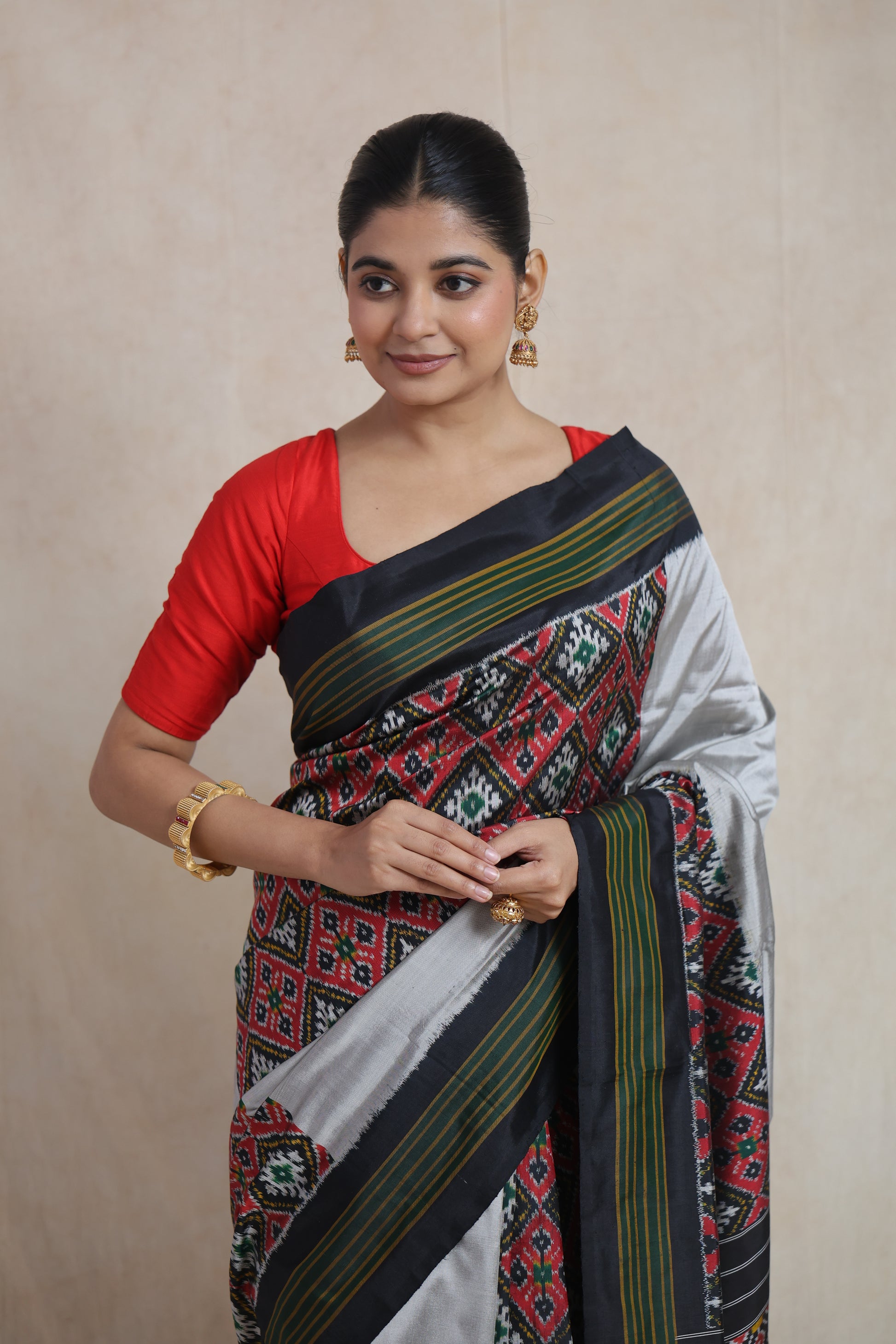 Close-up of black Panchampali handloom silk saree with intricate geometric ikat patterns and silver pallu