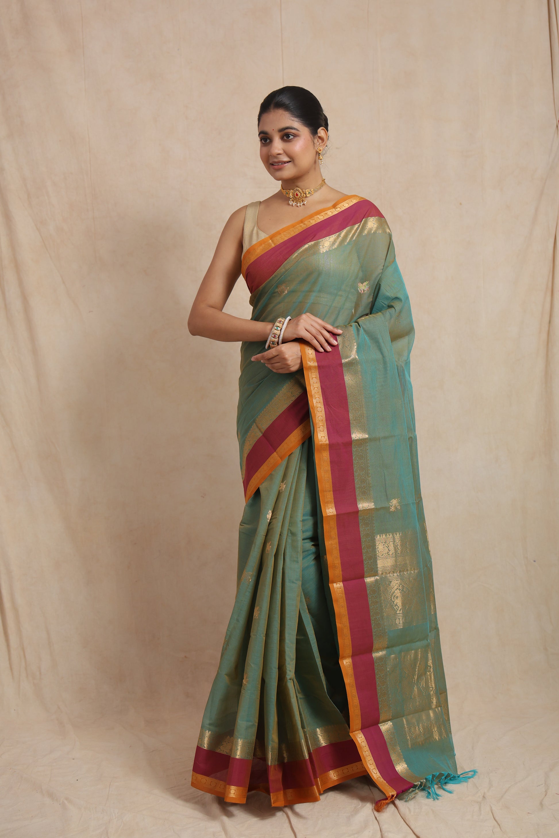 Classic pose in pastel aqua green Kanchipuram cotton saree