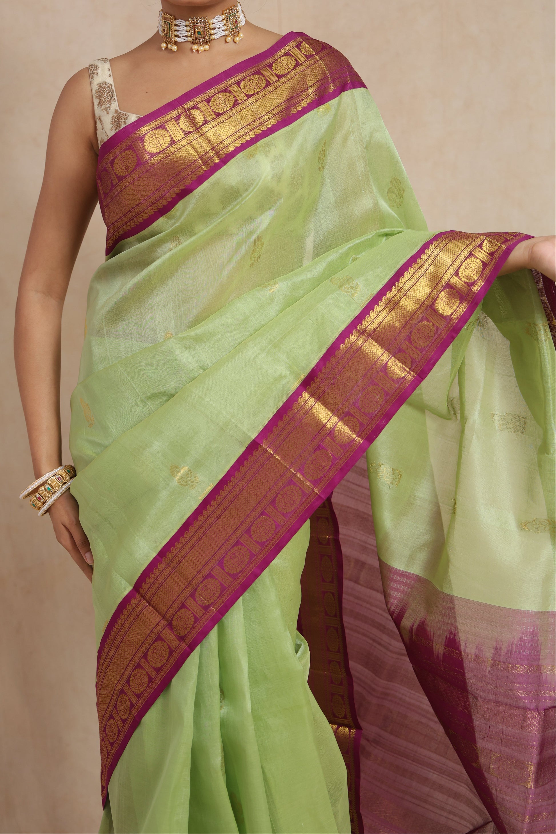 Close-up of pastel green Kanchipuram Sico saree with magenta zari border