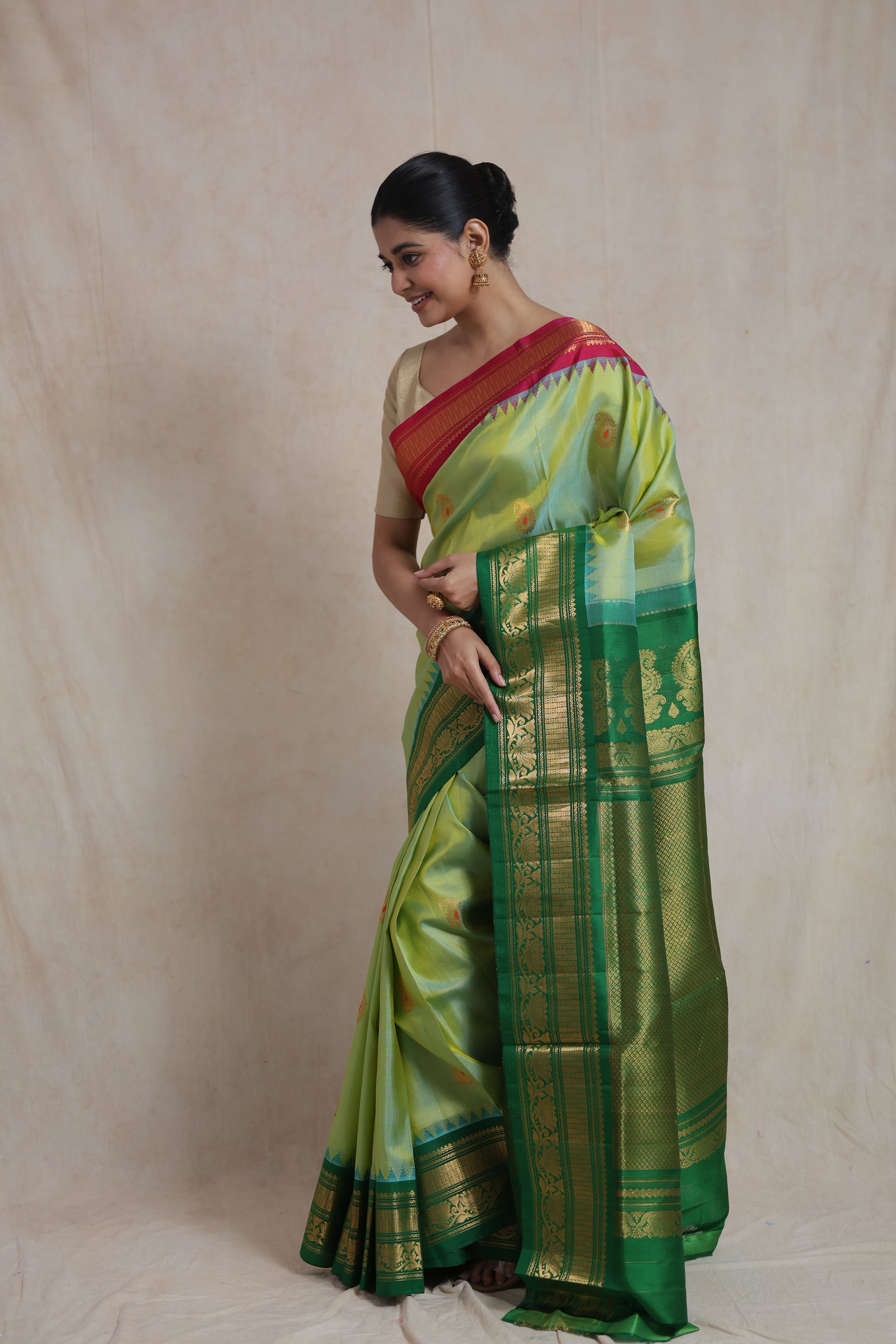 Side pose of Gadwal Sico saree with rich emerald green pallu