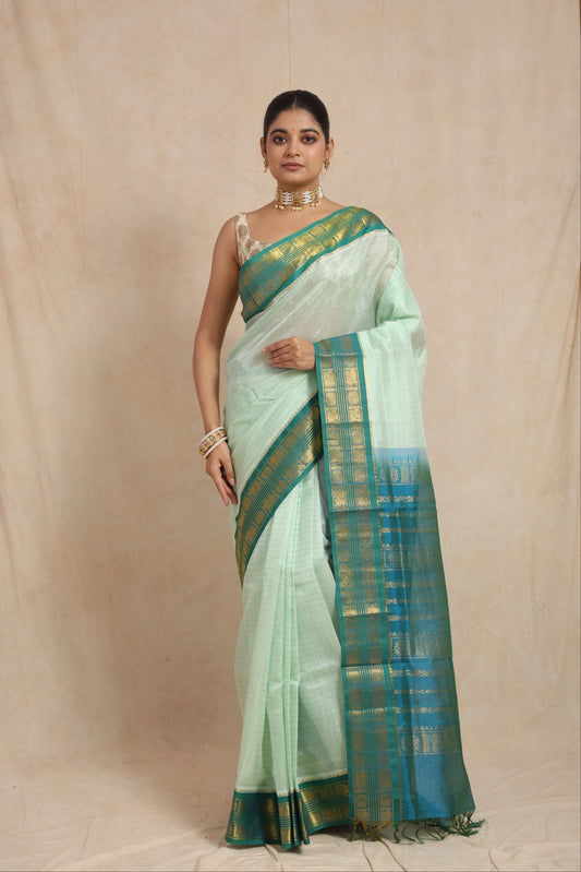 Elegant drape of pastel mint green Kanchipuram Sico saree with woven teal blue border