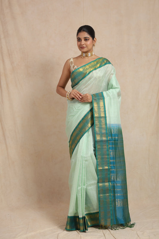 Full view of pastel mint green Kanchipuram Sico saree with teal blue zari border
