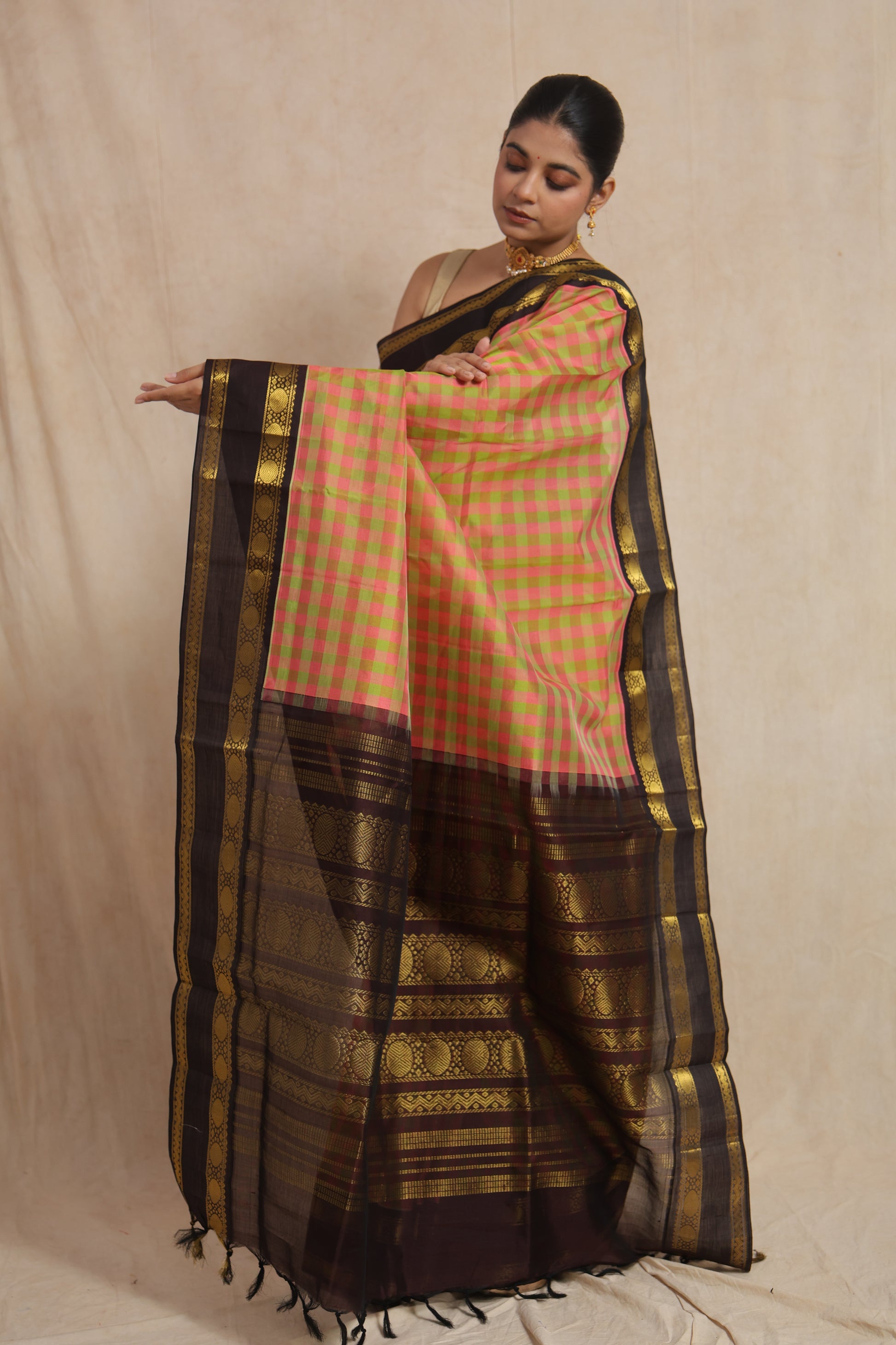 Elegant drape view of pastel pink checked Kanchipuram Sico saree with rich black woven pallu