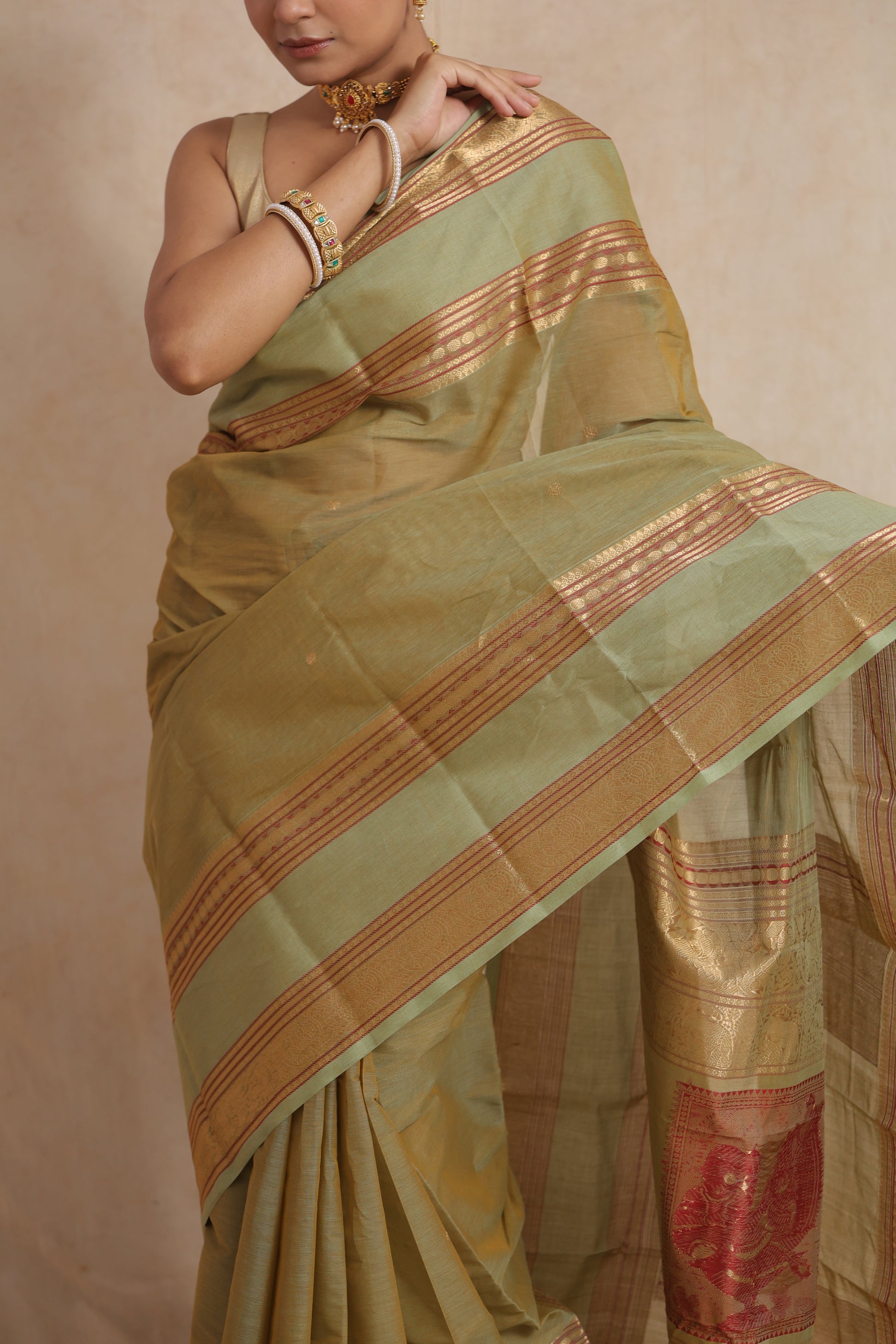 Detailed body texture of pastel sage green Kanchipuram cotton saree