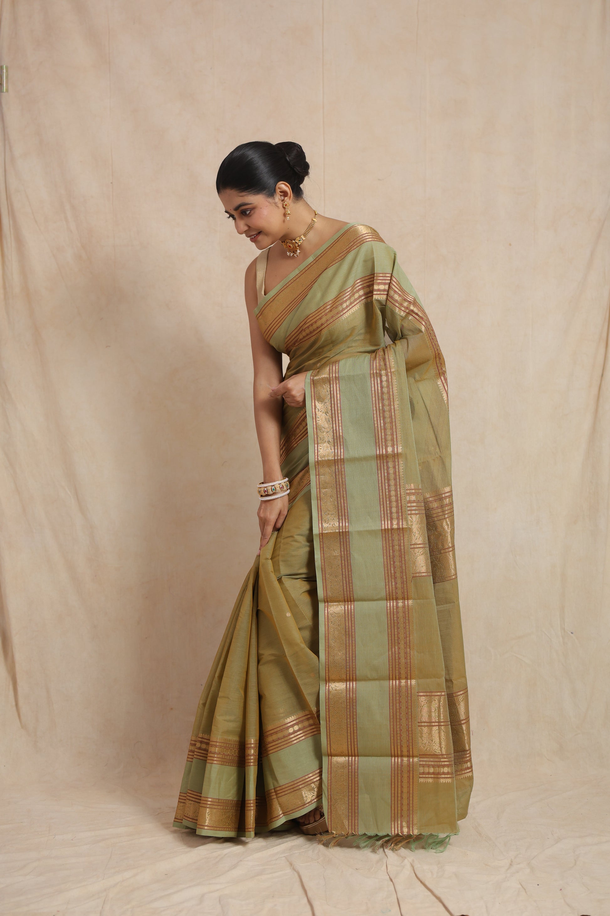 Graceful drape view of pastel sage green Kanchipuram cotton saree