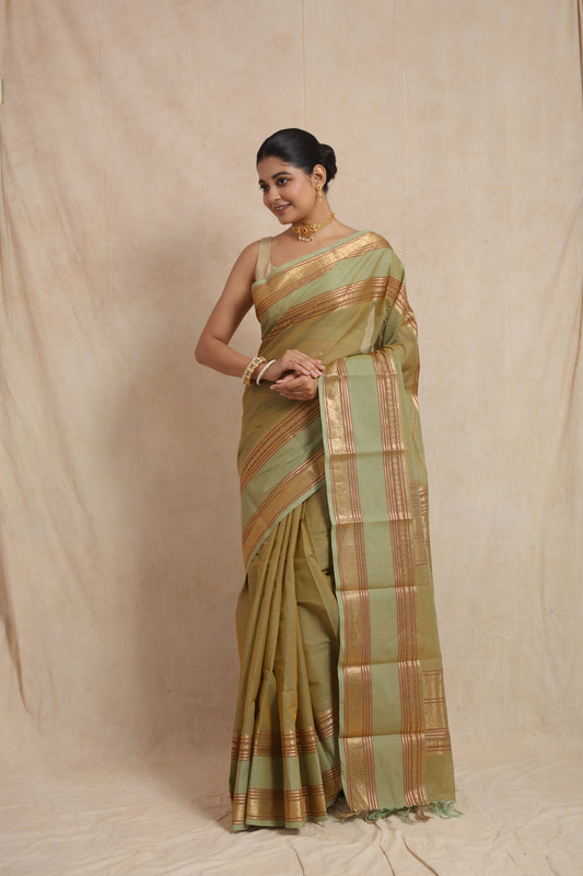 Elegant pose in pastel sage green Kanchipuram cotton saree