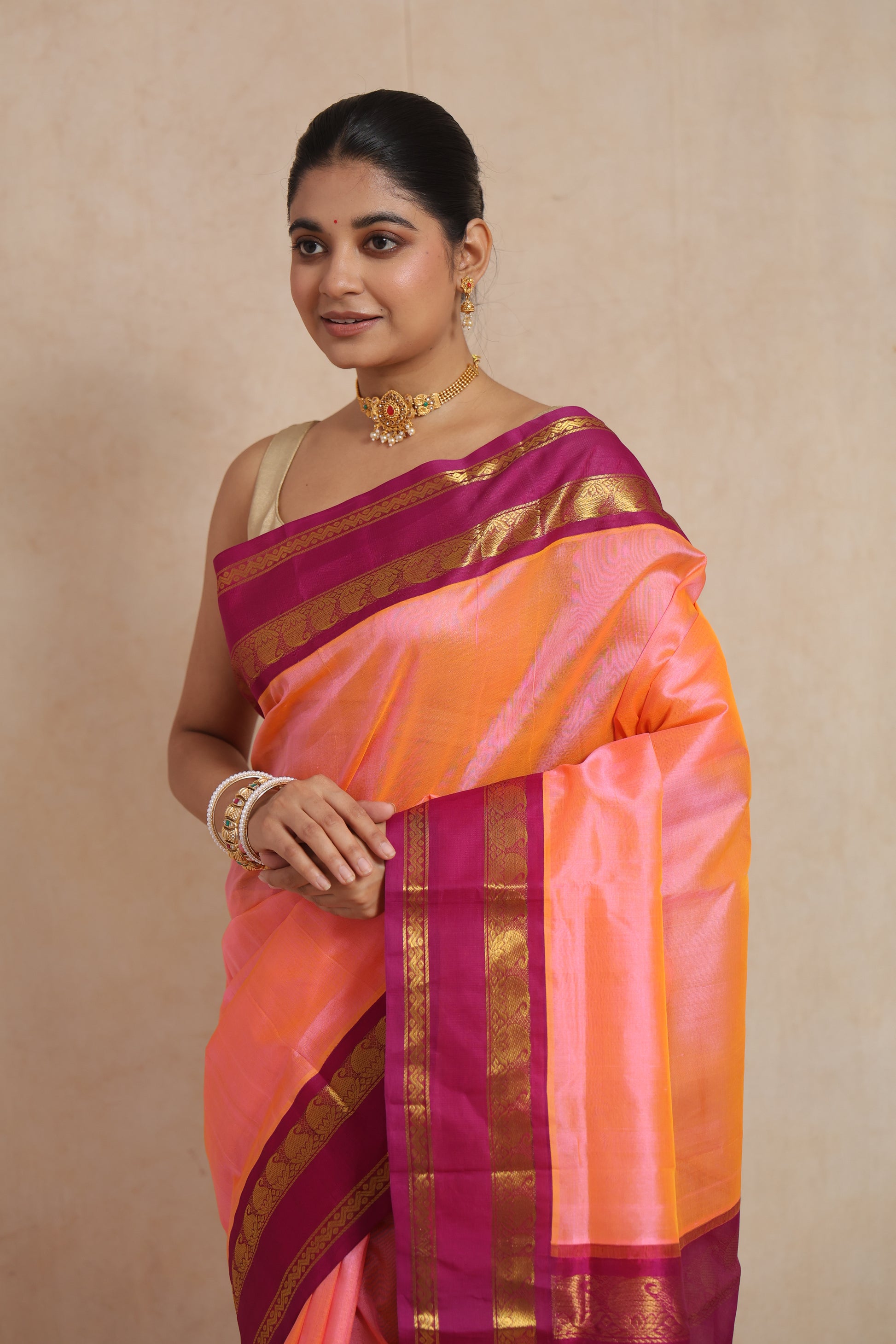 Elegant peach Kanchipuram silk cotton saree with traditional zari weaving