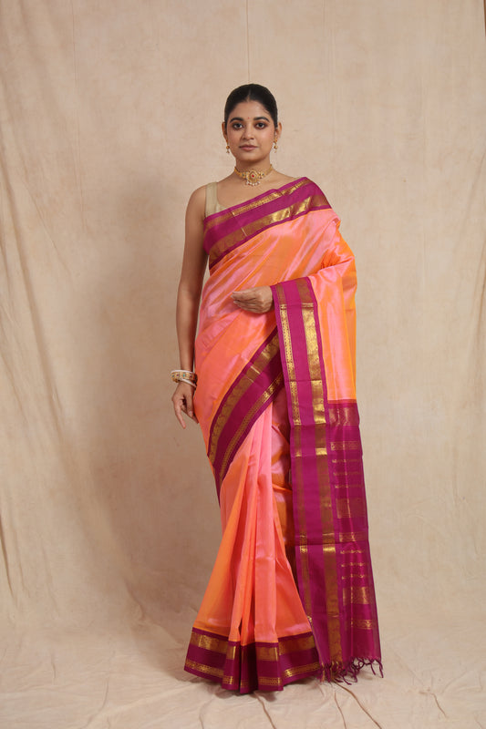 Full drape view of peach orange Kanchipuram Sico saree with traditional zari detailing