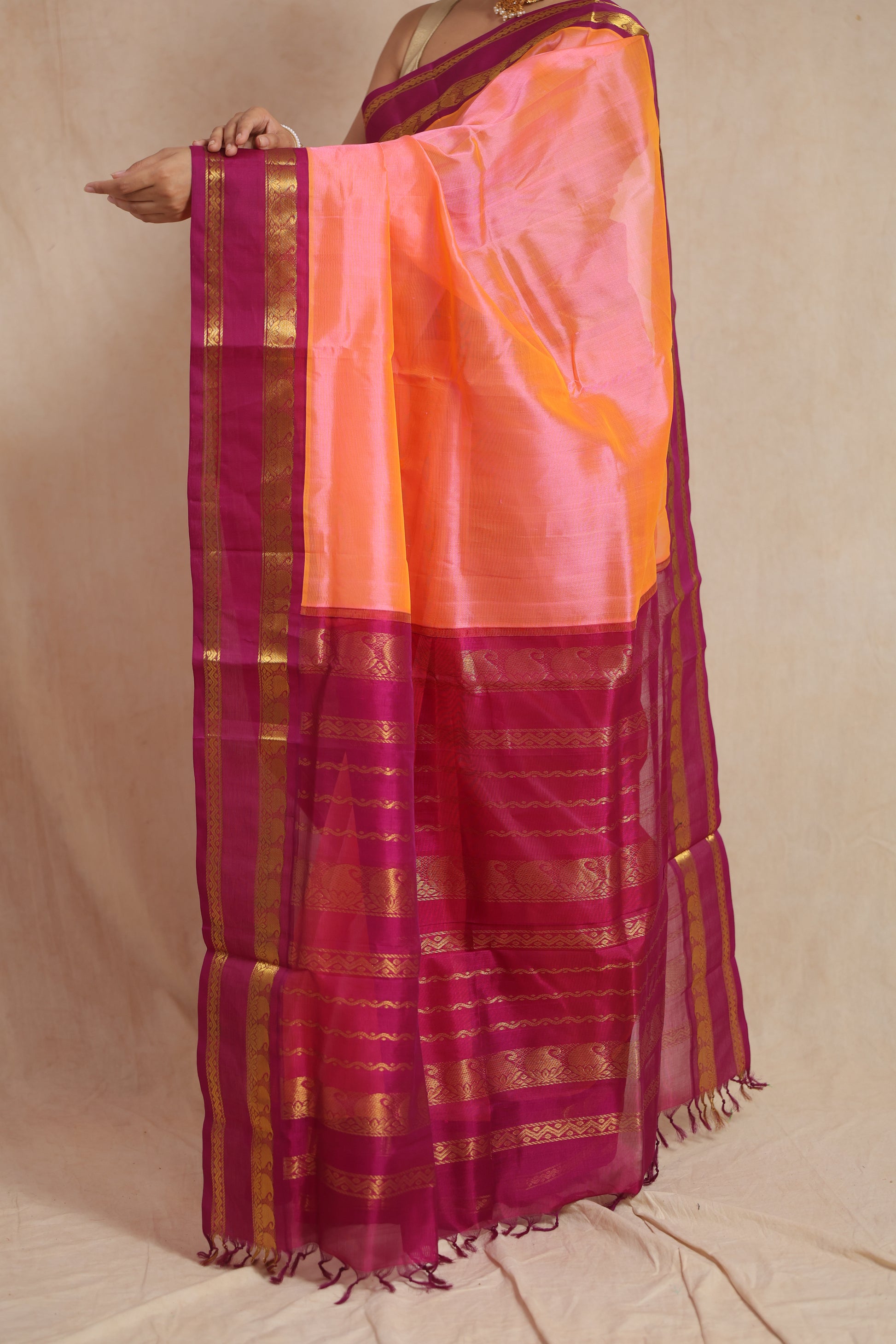 Detailed pallu view of peach orange Kanchipuram Sico saree with woven zari border