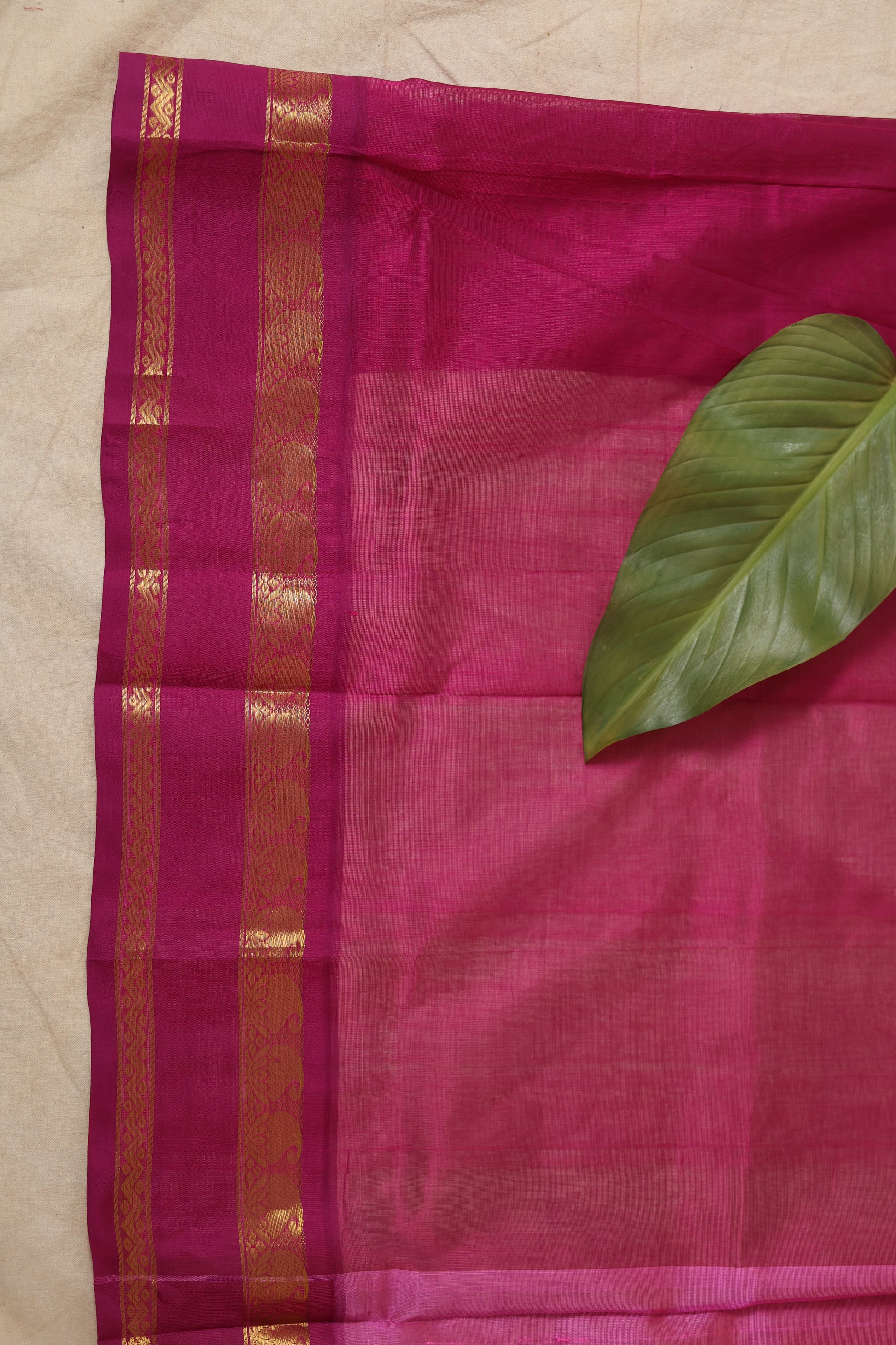 Closeup view of peach Kanchipuram silk cotton saree with zari border