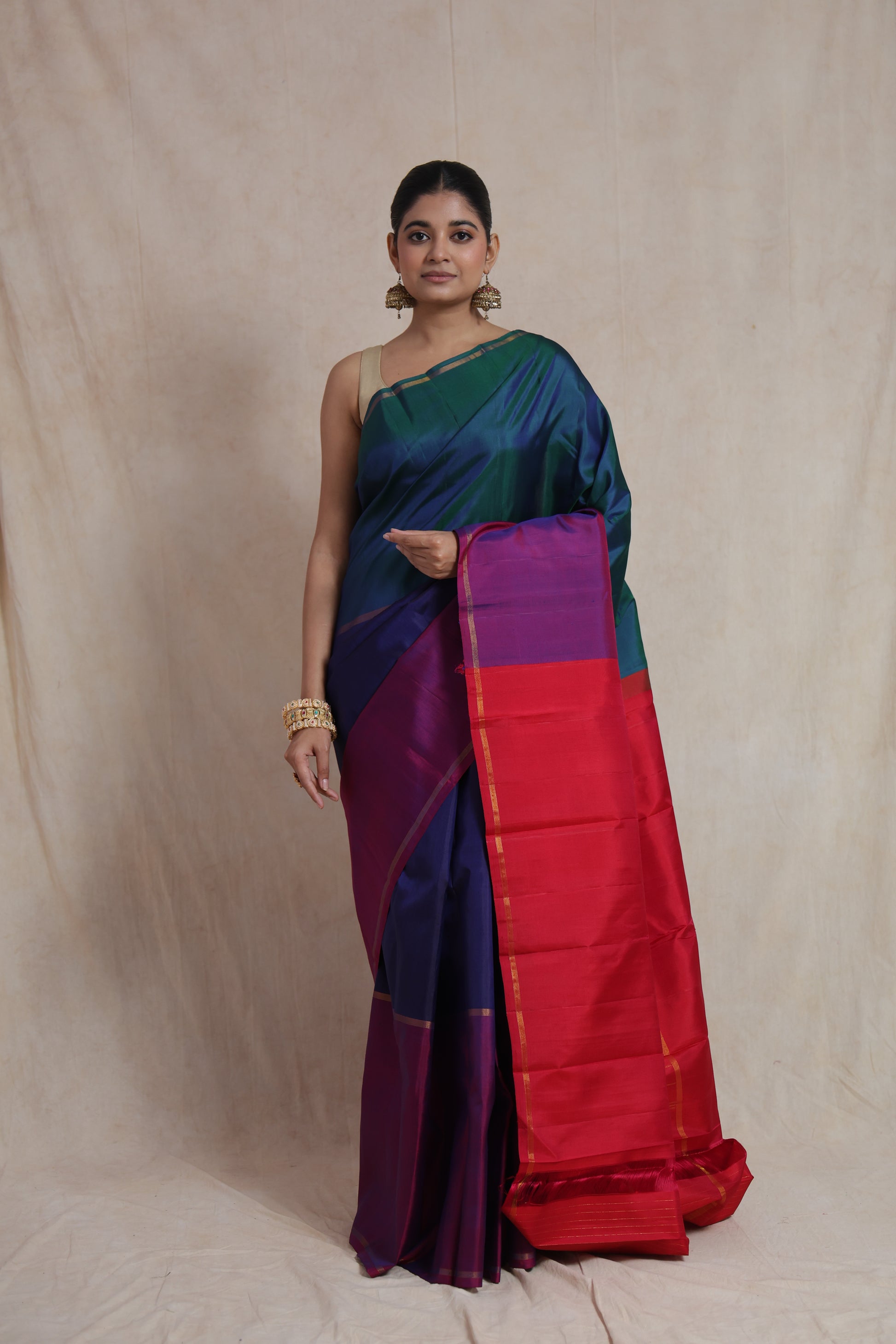 Front view of peacock blue and emerald green Kanjivaram pure silk saree with vibrant pink pallu