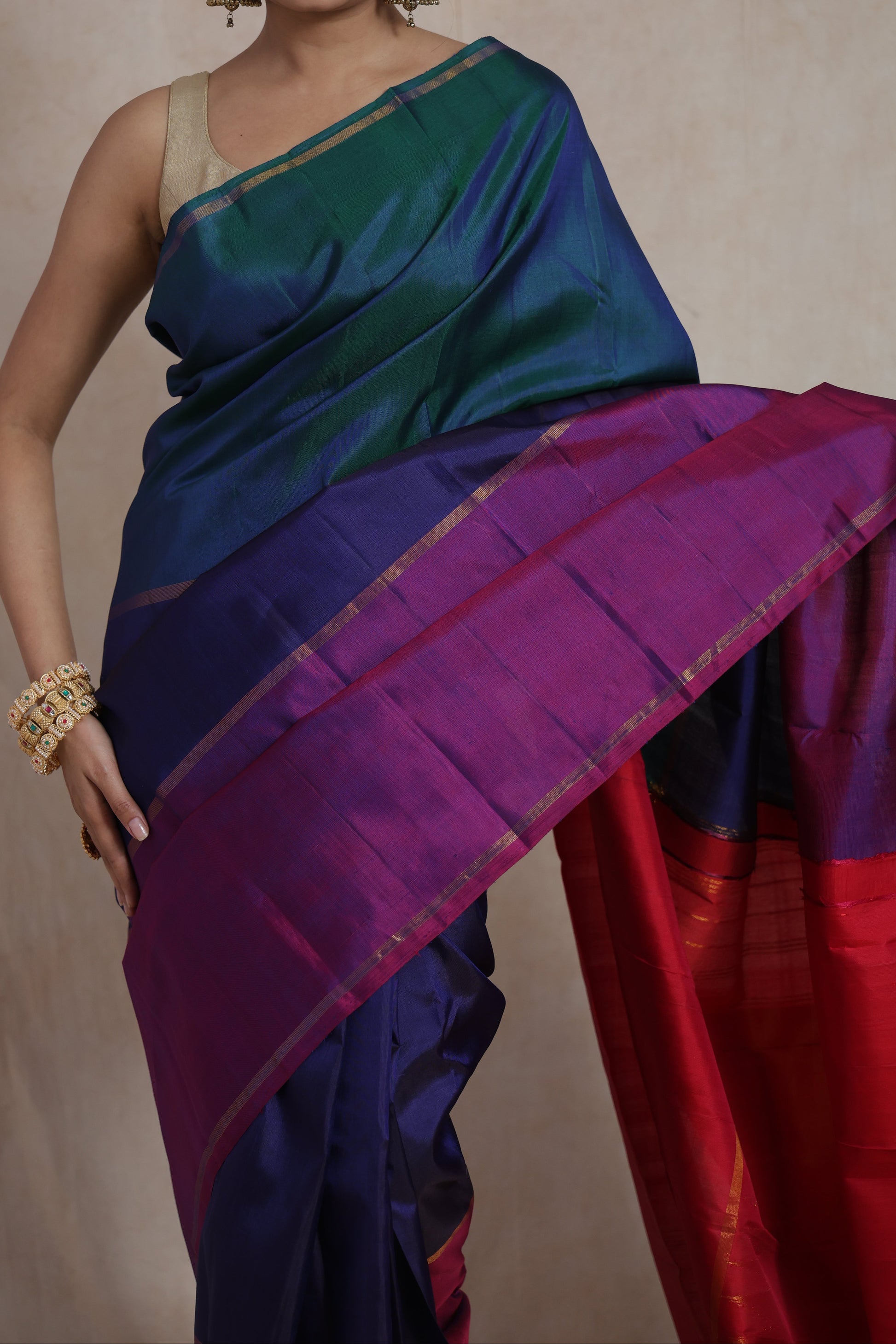 Close-up of lustrous peacock blue Kanjivaram pure silk saree with pink pallu and border