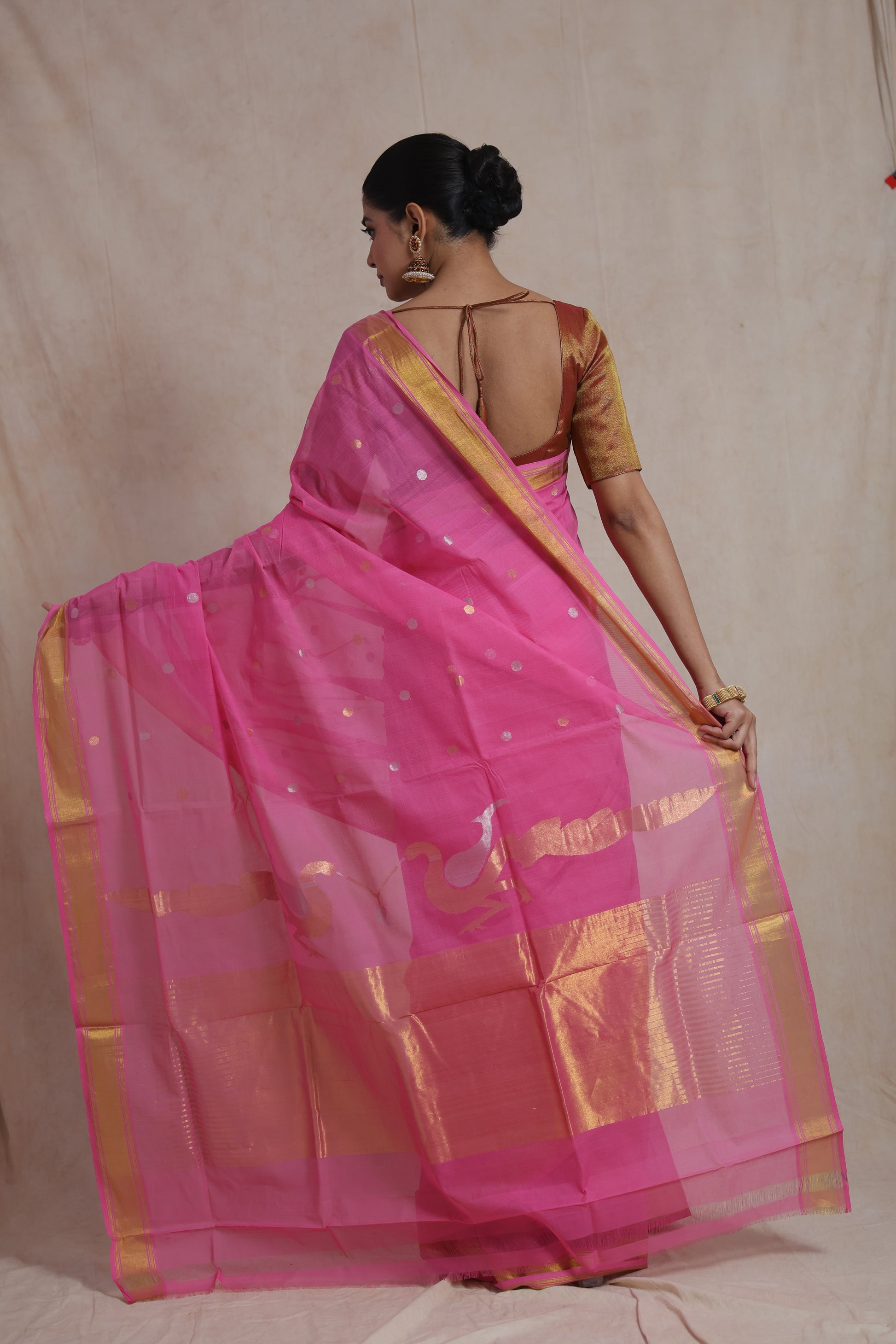 Side pose of pink Kanchipuram cotton saree with woven border