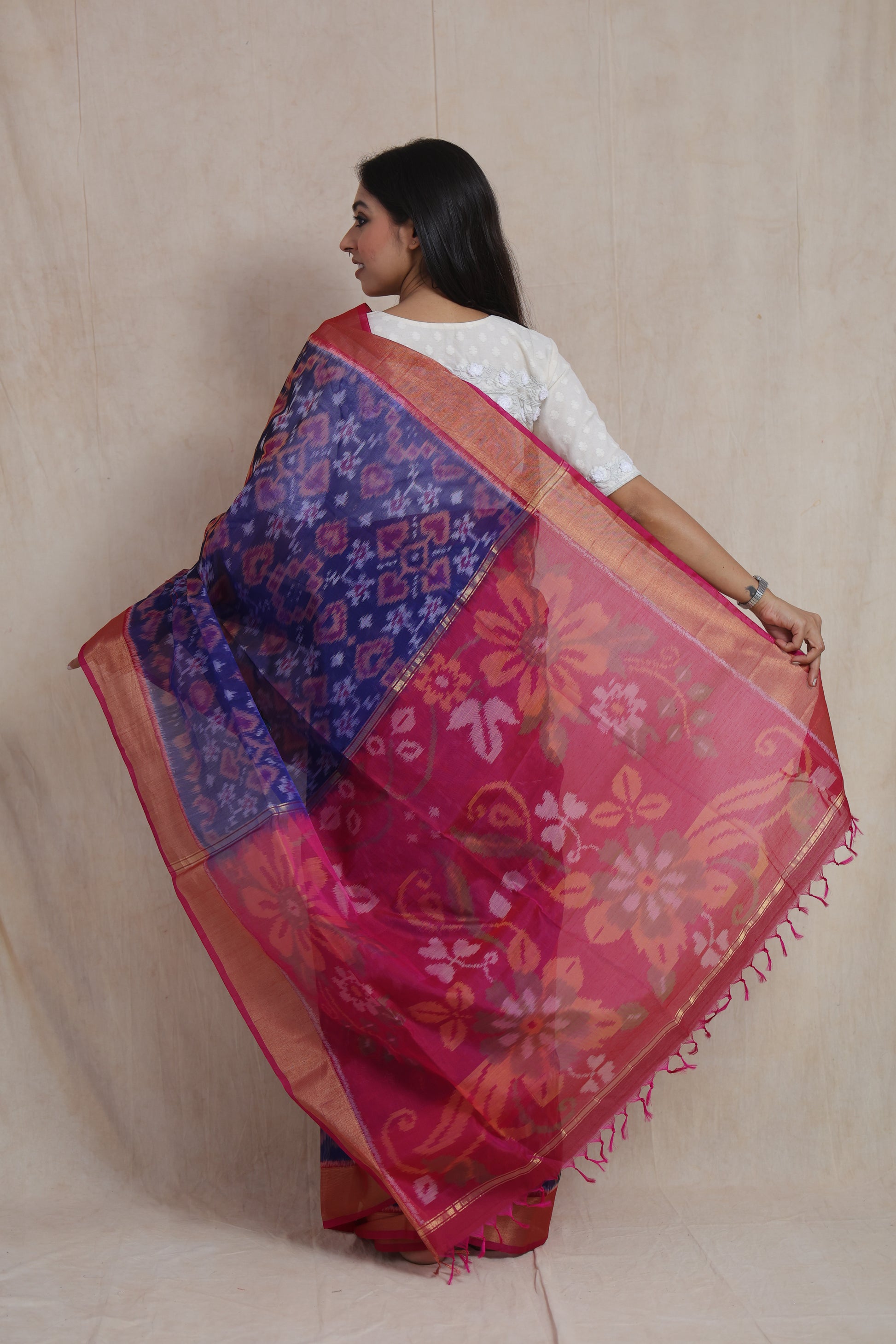 Back view of Panchampali handloom silk cotton saree showcasing floral pink pallu and intricate Ikat weave patterns