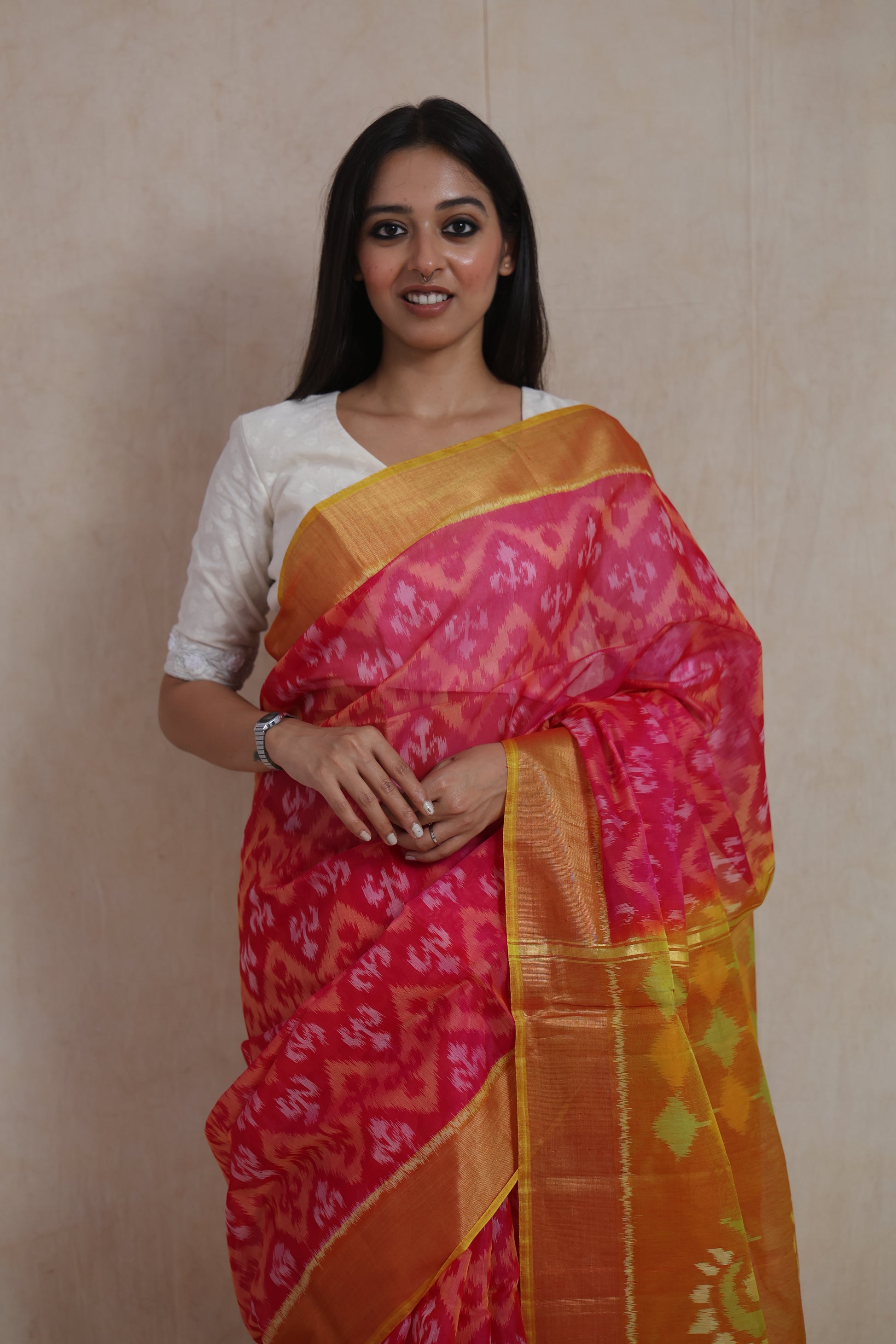 Front portrait view of Rani pink Pochampally silk cotton saree with vibrant Ikat weave