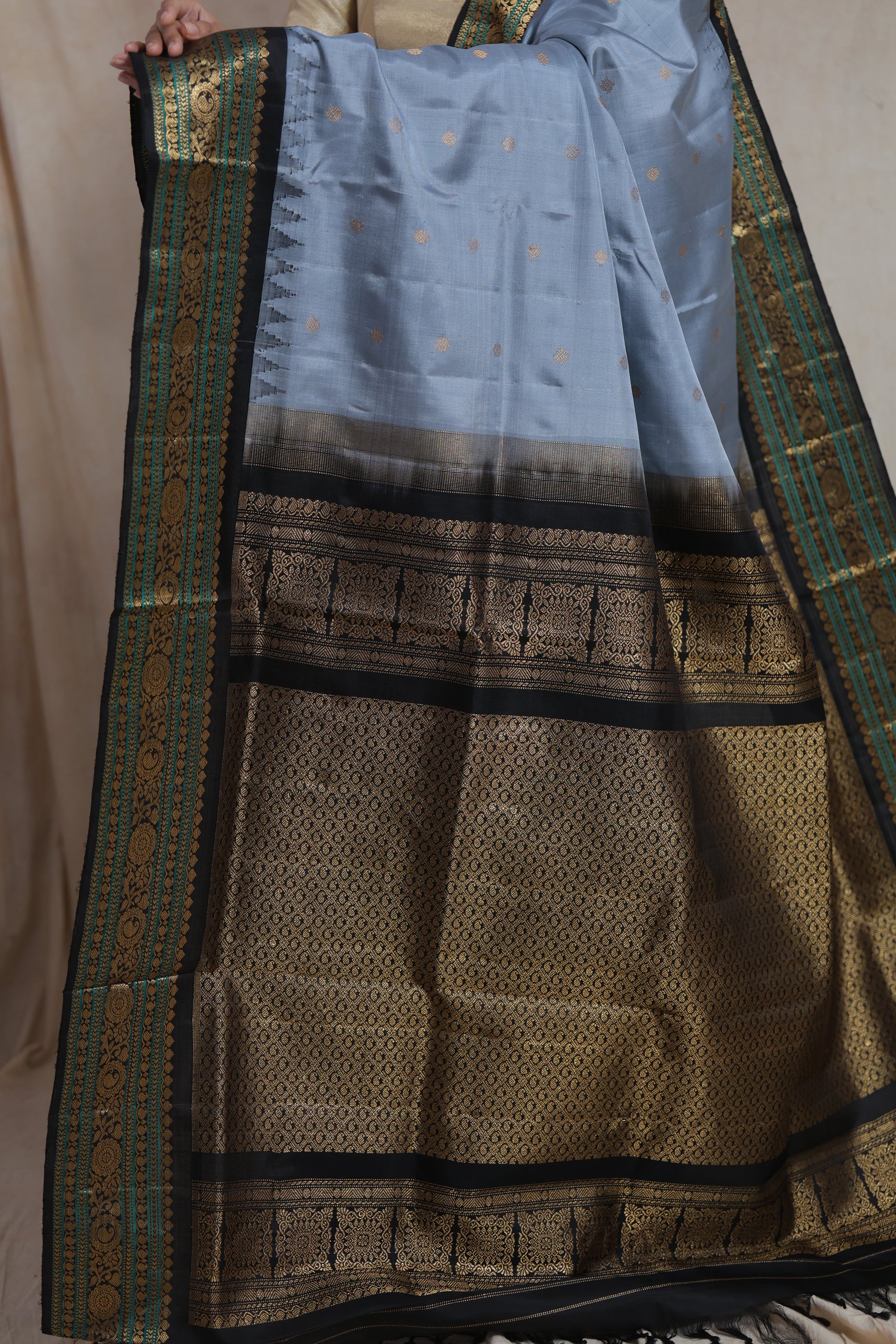 Detailed pallu view of powder blue Gadwal Silk saree with antique gold woven border