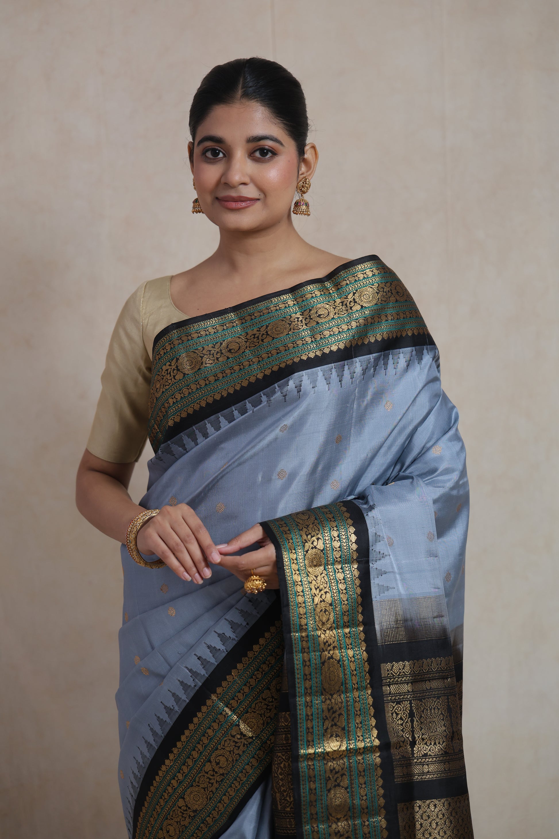 Portrait view of powder blue Gadwal Silk saree with intricate antique gold border
