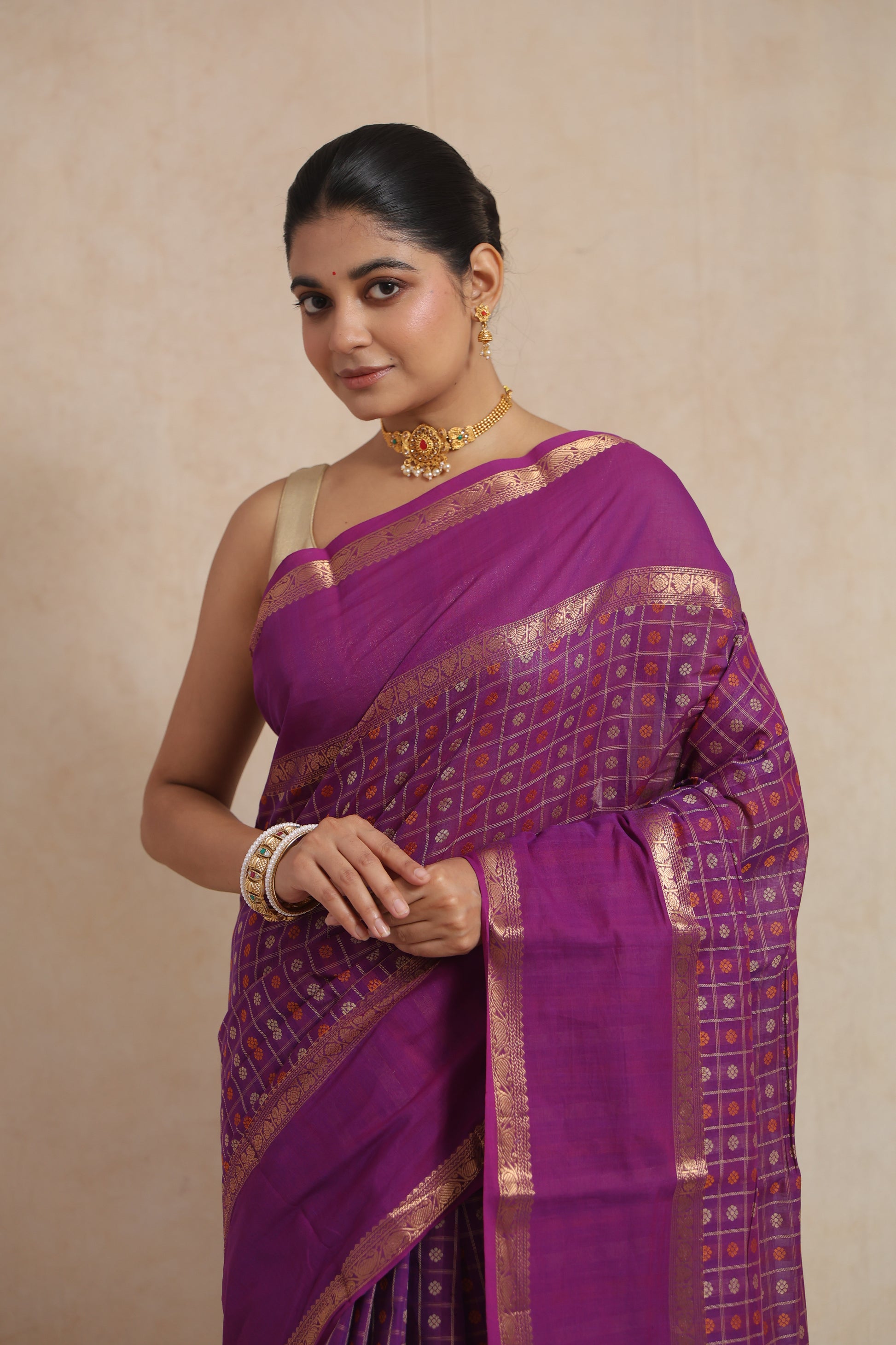 Close-up view of purple Kanchipuram cotton saree with gold checks