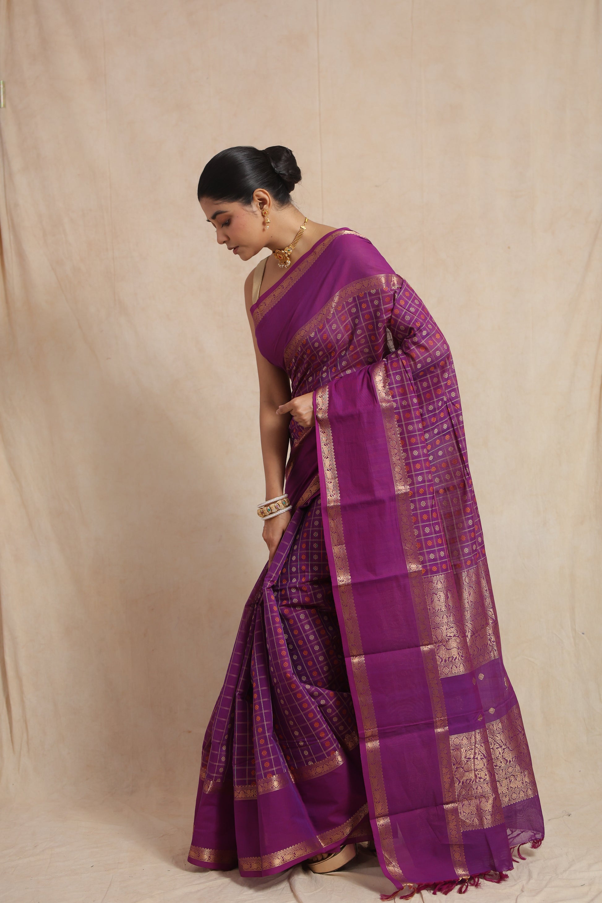 Side pose in purple Kanchipuram cotton saree