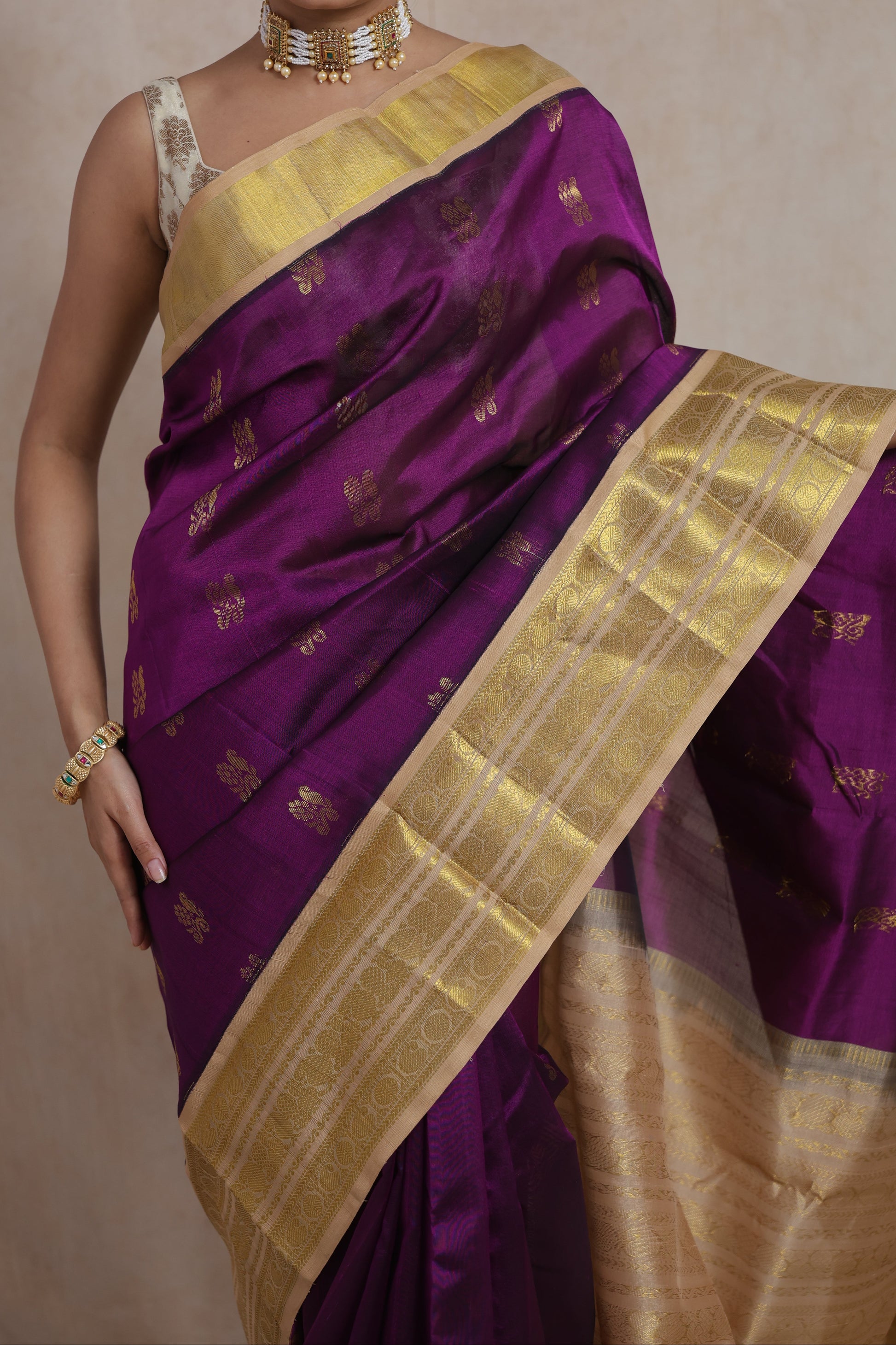 Close-up of royal purple Kanchipuram SICO saree with delicate woven buttas and ornate gold border