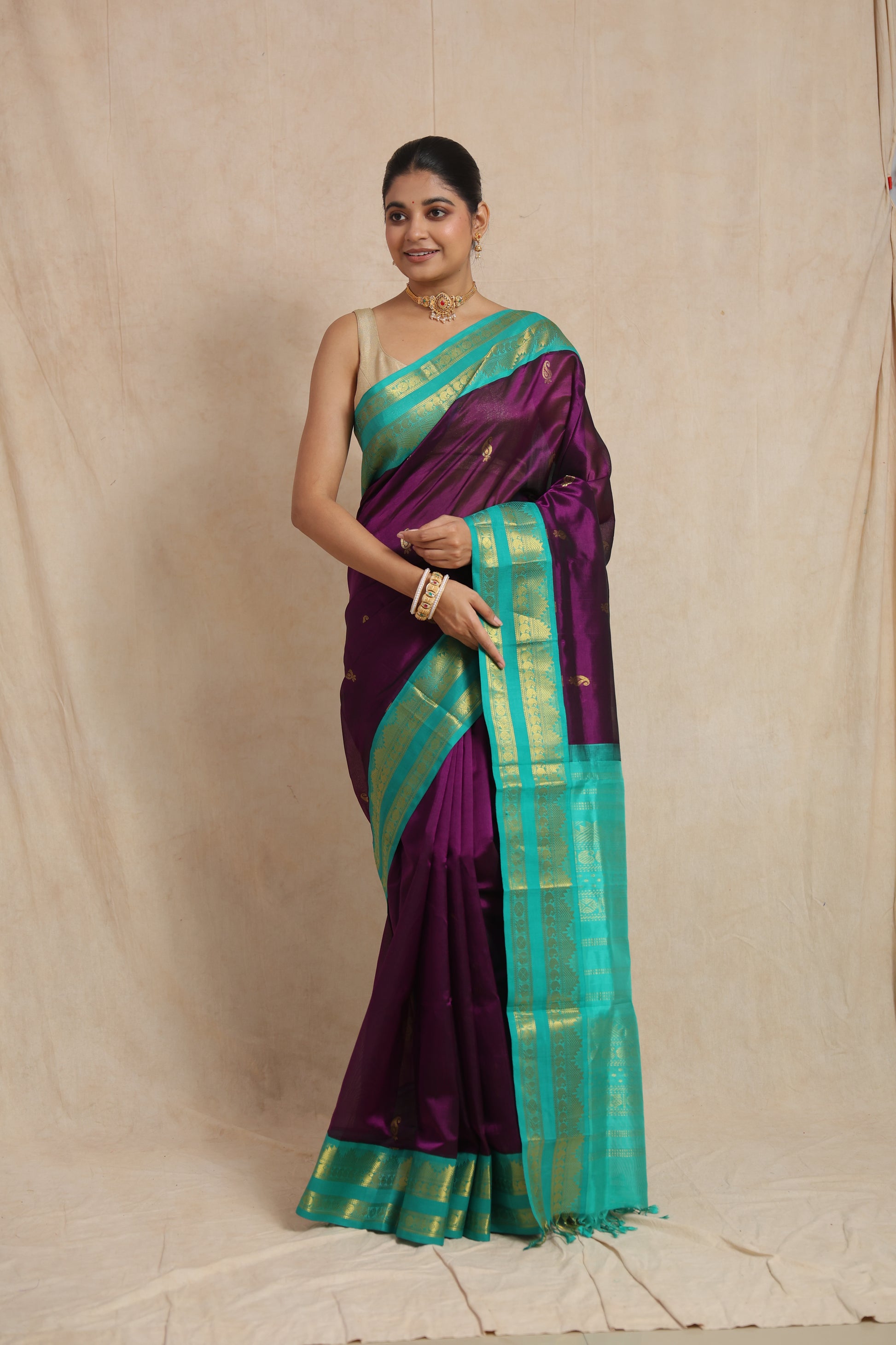 Full view of royal purple Kanchipuram Sico saree with aqua blue zari border