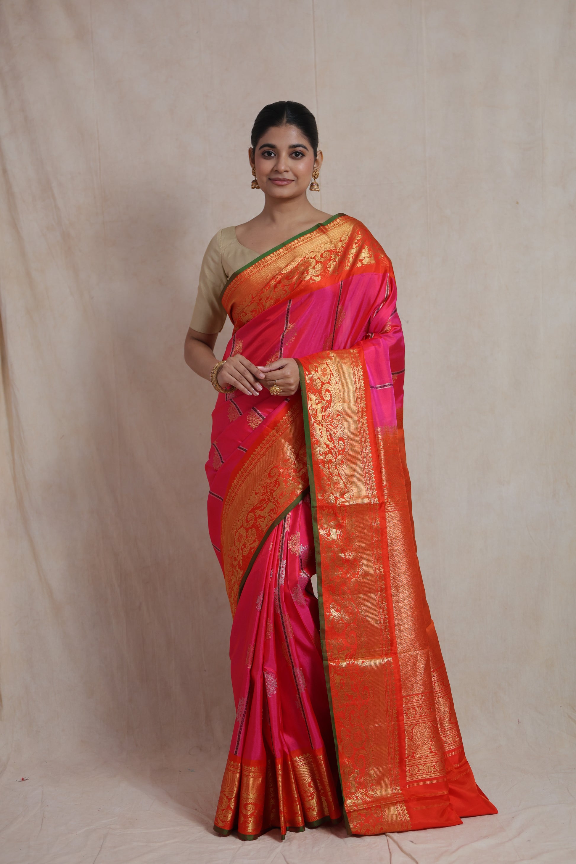 Full drape look of rani pink Gadwal SICO saree with contrast orange pallu