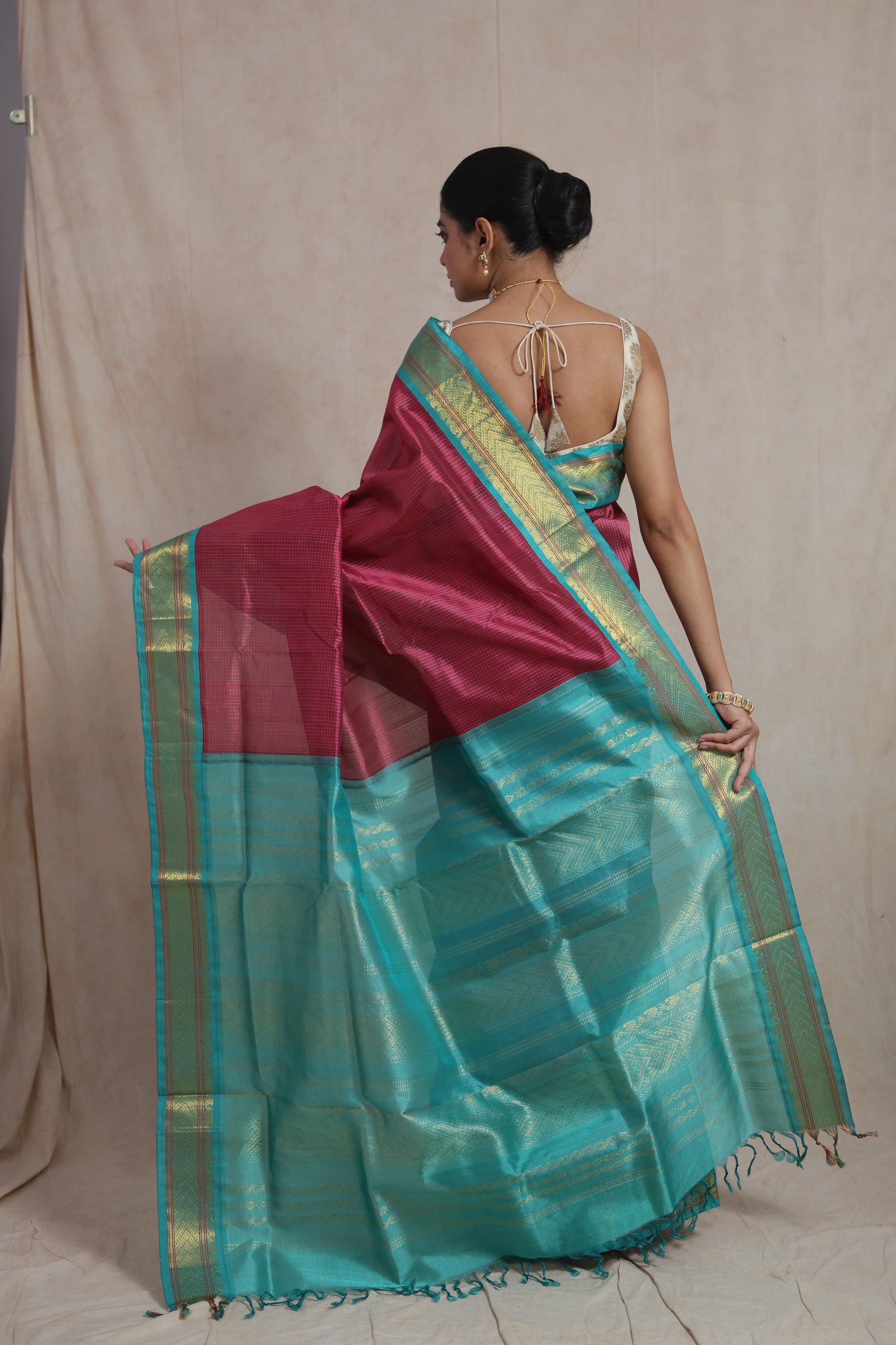 Back view of rani pink silk cotton saree with aqua blue zari pallu