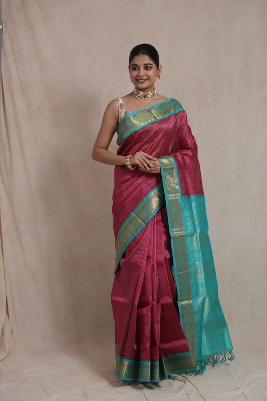 Elegant look in rani pink silk cotton saree with aqua blue woven border