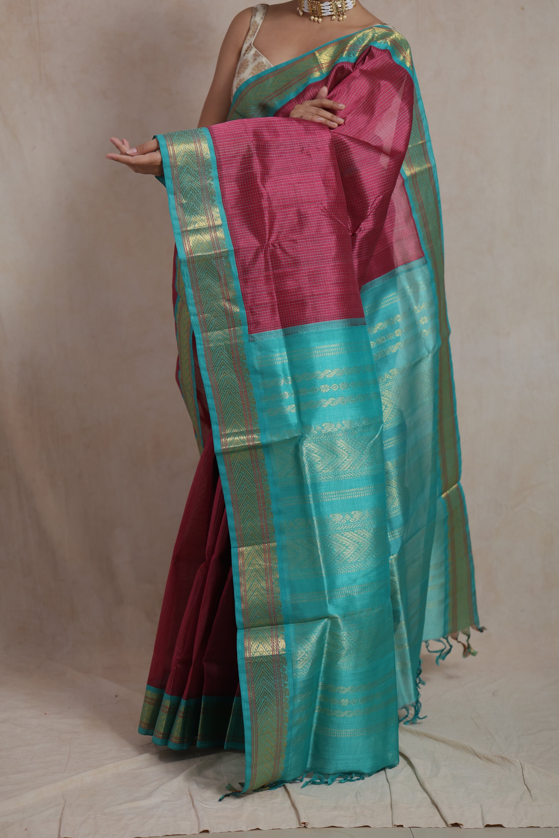 Detailed shot of rani pink silk cotton saree with aqua blue border