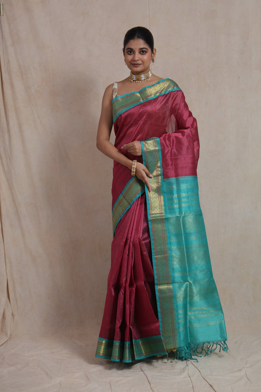 Front view of rani pink Kanchipuram silk cotton saree with aqua blue zari border