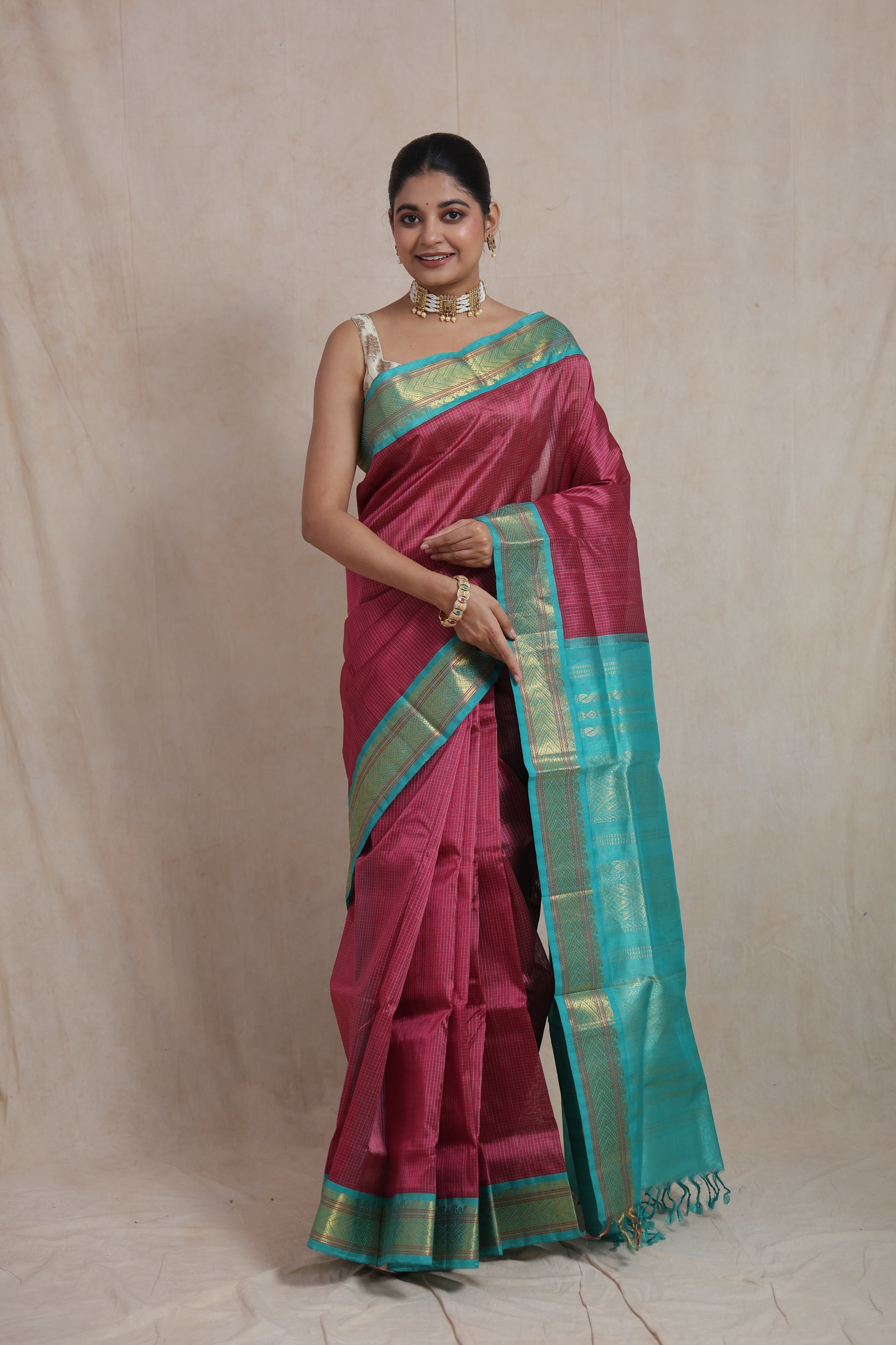 Full drape of rani pink Kanchipuram silk cotton saree with contrast pallu
