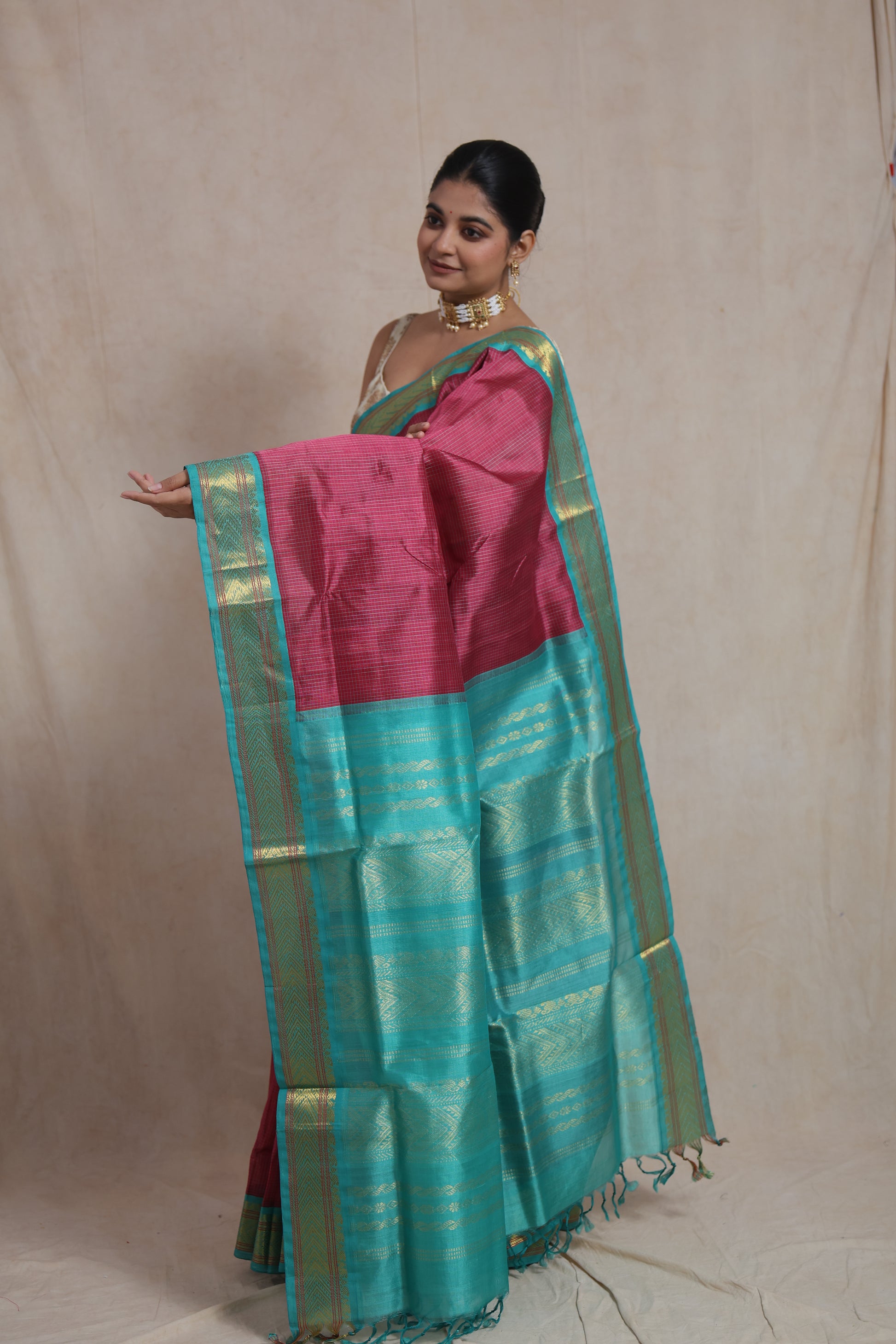 Pallu display of rani pink Kanchipuram silk cotton saree with zari weaving
