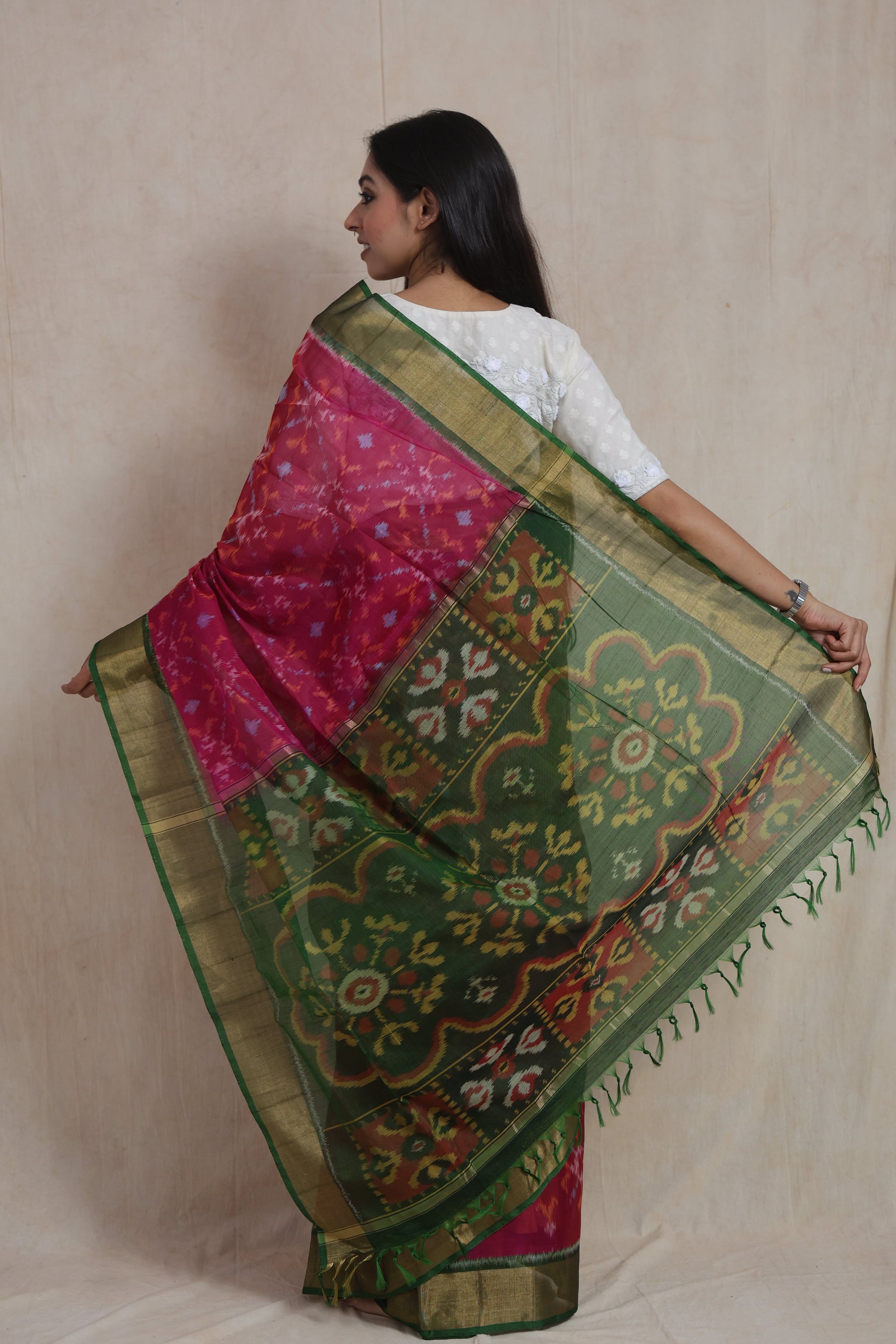 Back view showcasing the intricate emerald green pallu of a rani pink Panchampali SICO saree