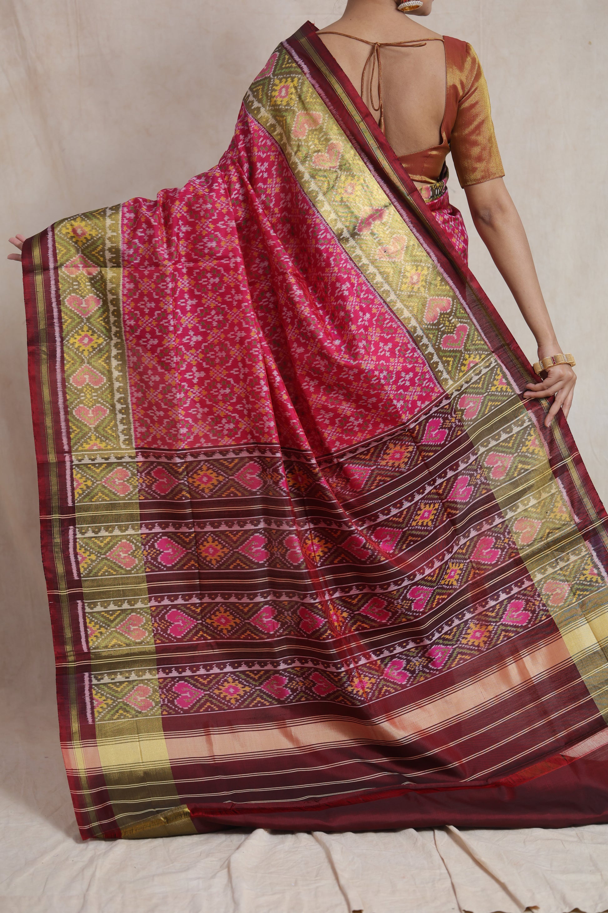 Back view of rani pink Patola silk saree with rich woven pallu
