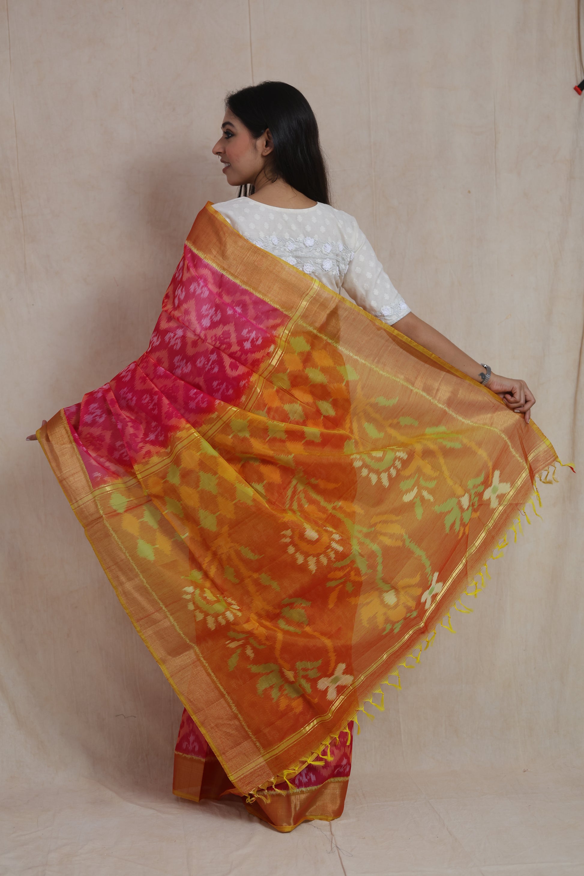 Back drape view of Rani pink Pochampally silk cotton saree with artistic floral pallu