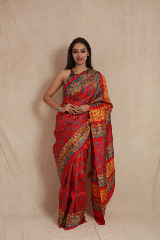 Front drape view of royal red Batik silk saree with geometric woven patterns