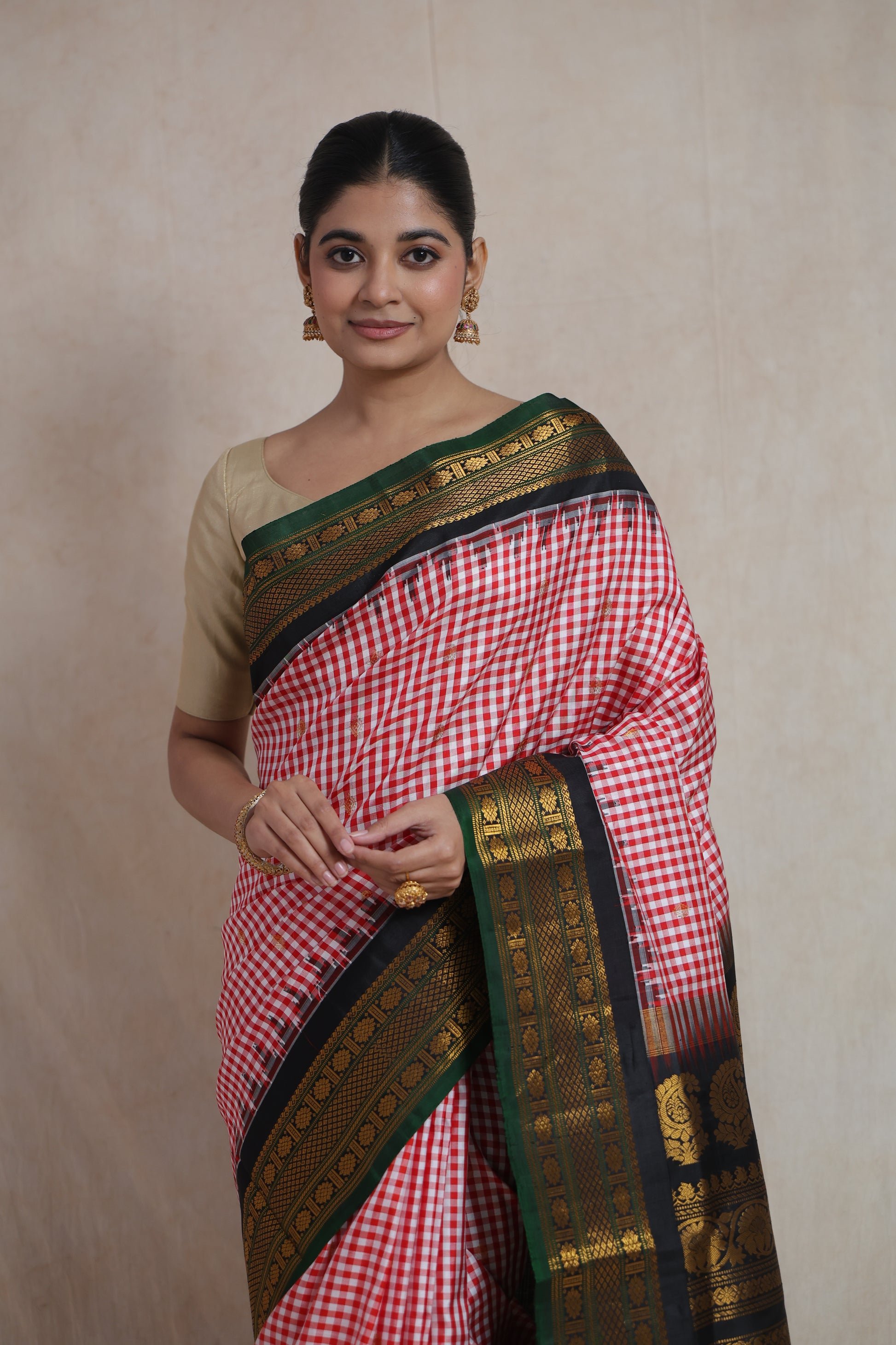 Elegant portrait view of red checked Gadwal Silk saree with rich border