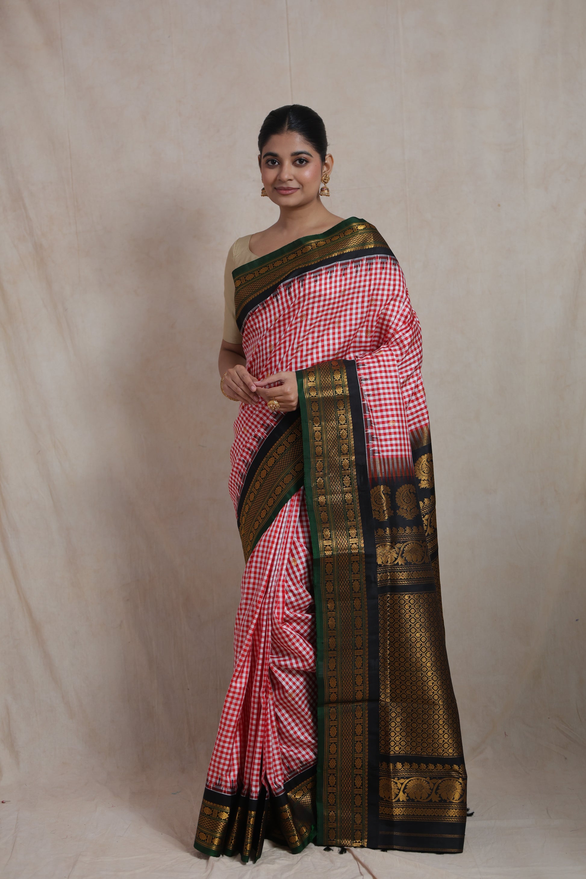 Full look of red checked Gadwal Silk saree with black zari woven pallu