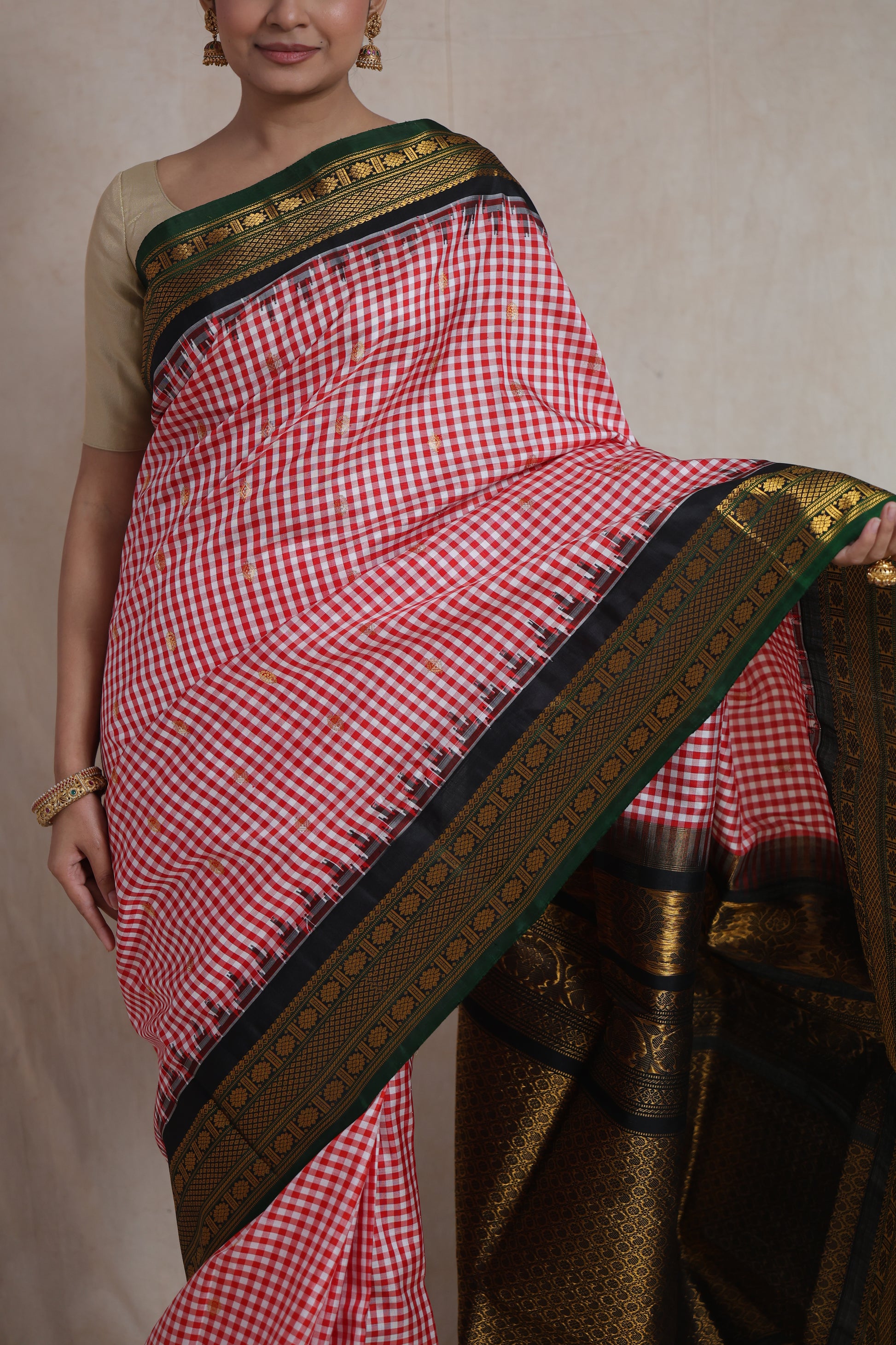 Full look of red checked Gadwal Silk saree with black zari woven pallu