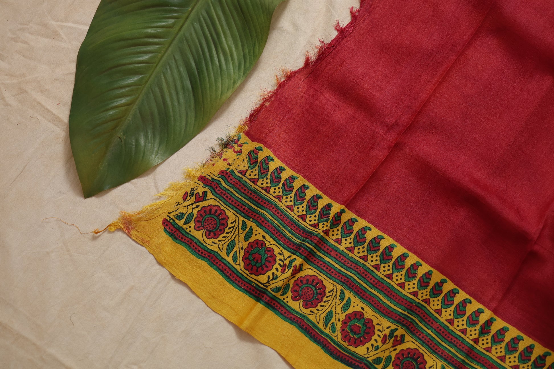 Pallu detail of red Garad silk saree with floral motifs